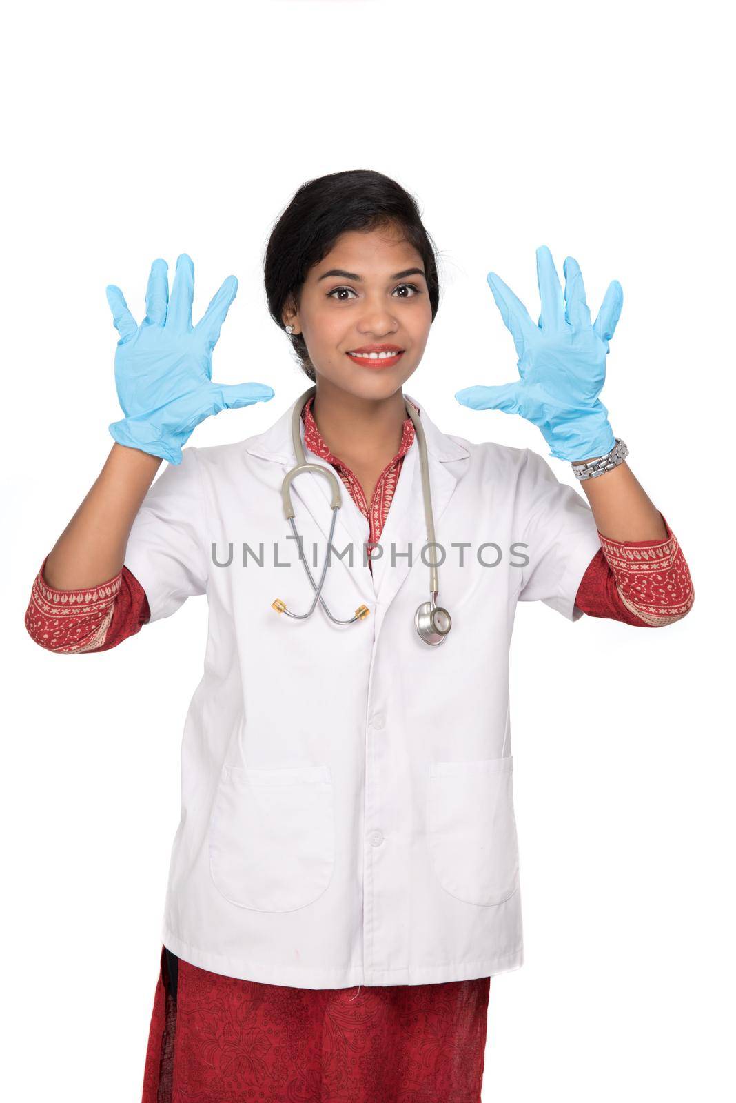 Woman doctor wears medical gloves.
