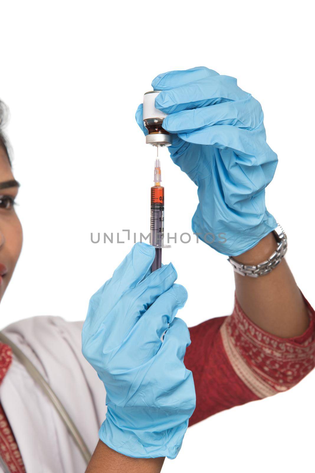 A female doctor with a stethoscope is holding an Injection or Syringe. by DipakShelare