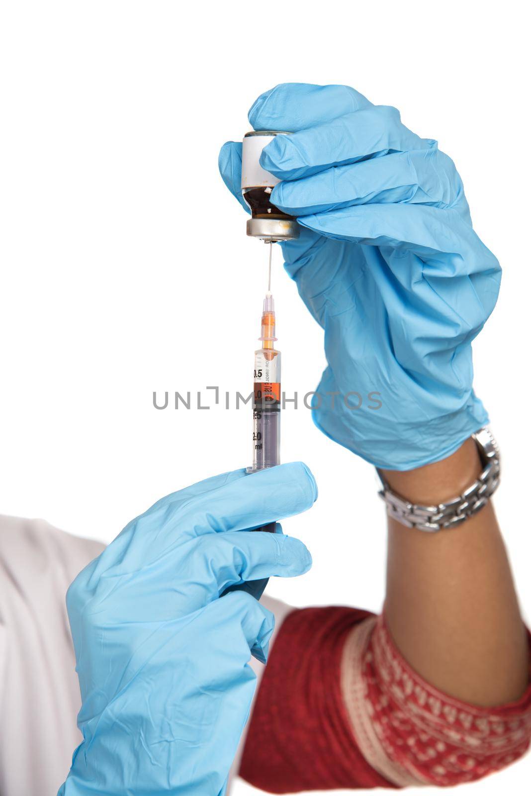 A female doctor with a stethoscope is holding an Injection or Syringe.