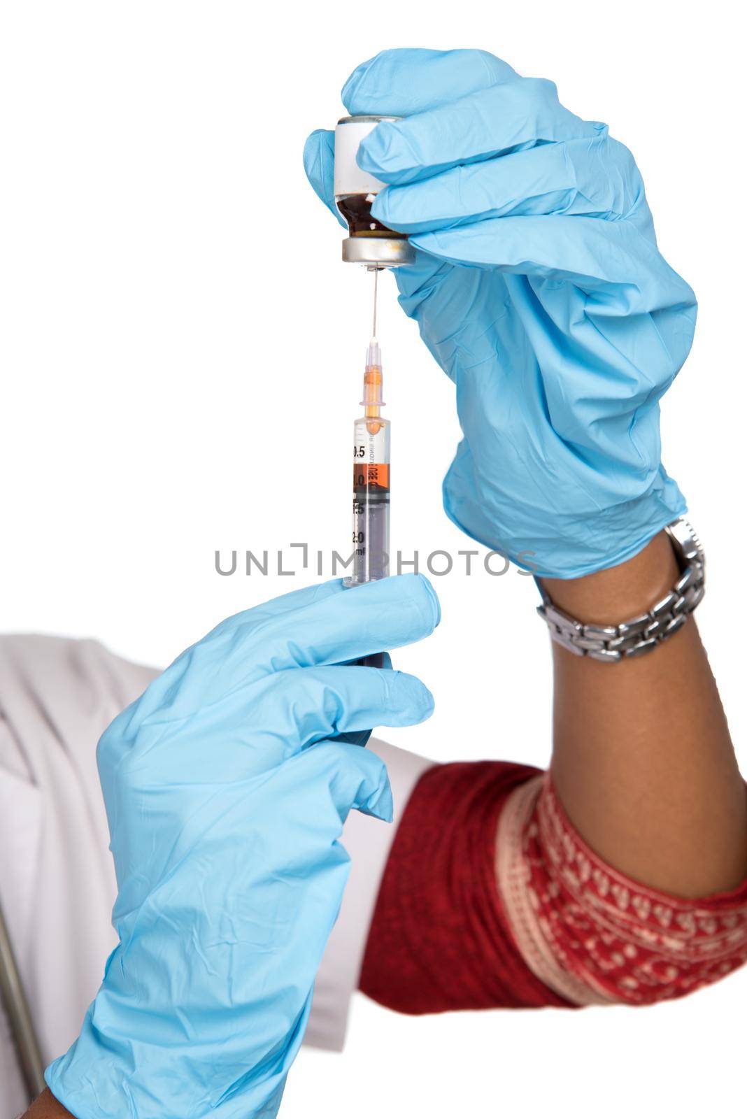 A female doctor with a stethoscope is holding an Injection or Syringe.