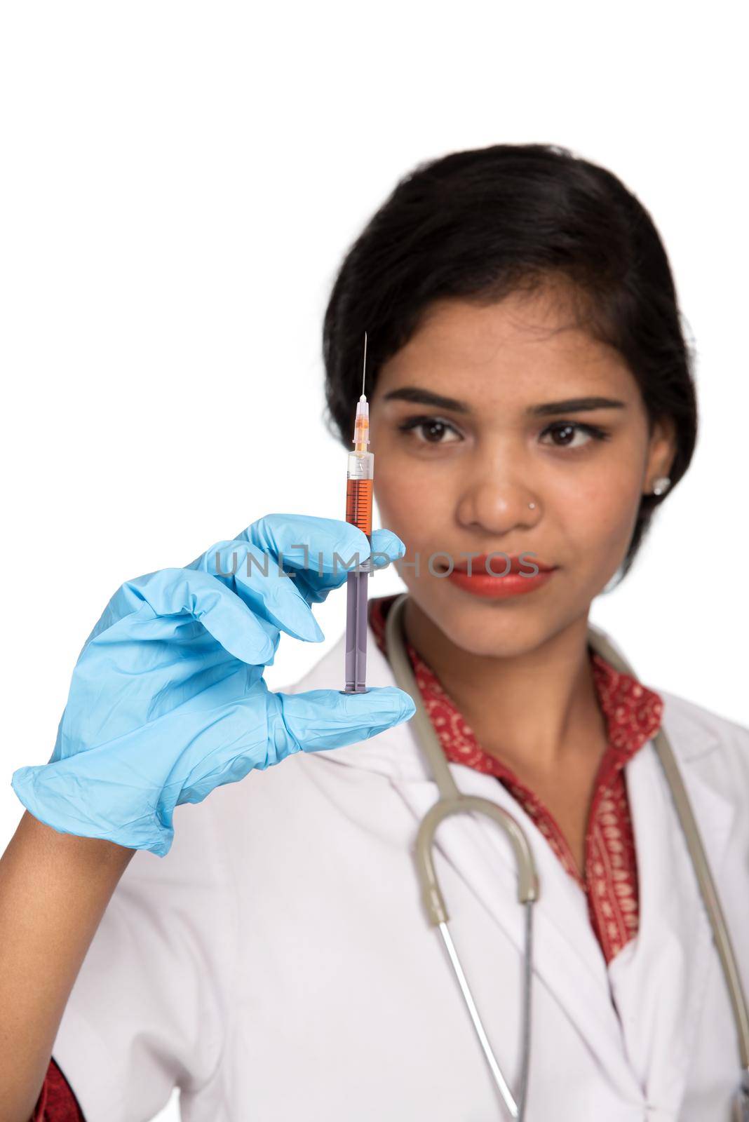 A female doctor with a stethoscope is holding an Injection or Syringe.