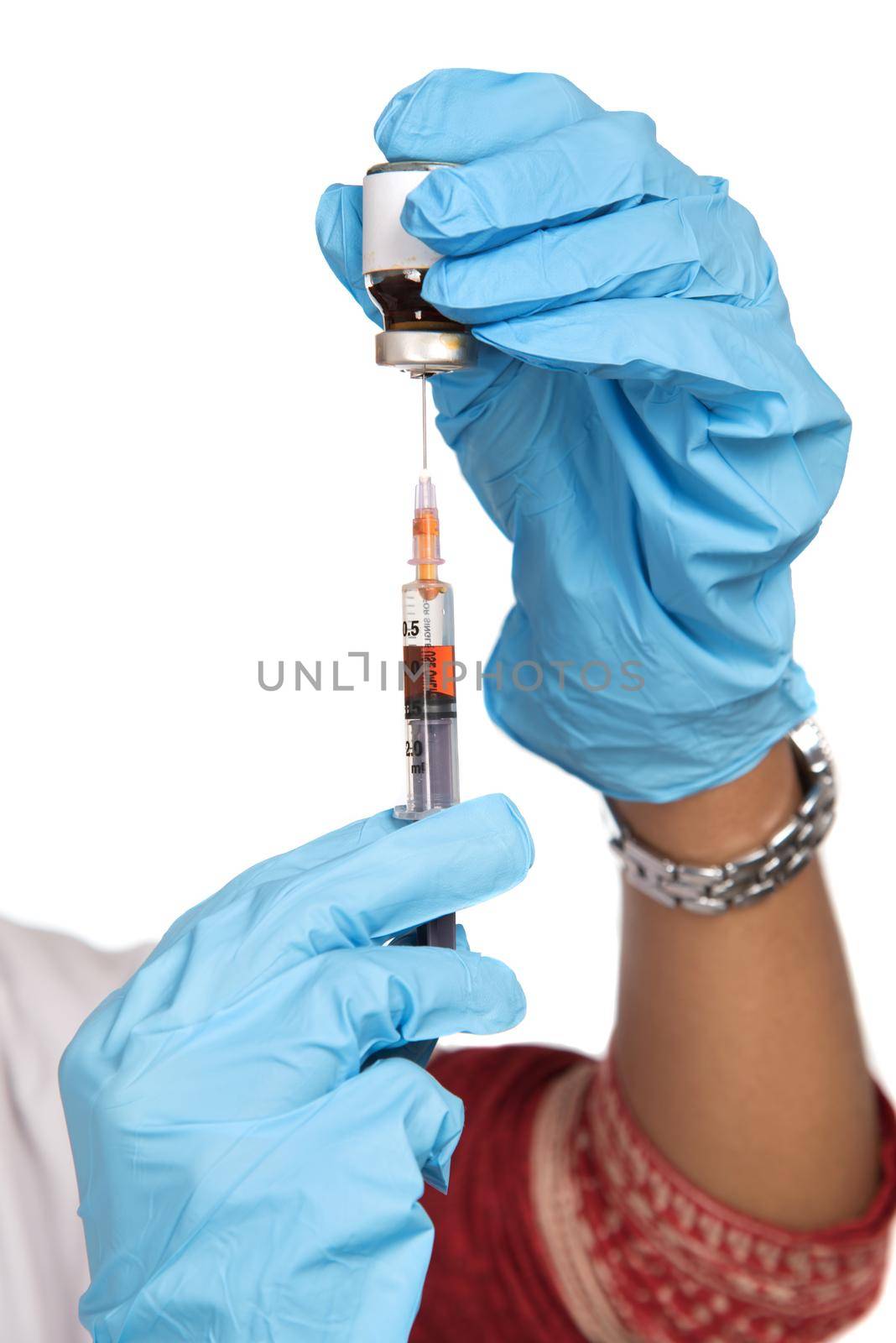 A female doctor with a stethoscope is holding an Injection or Syringe. by DipakShelare