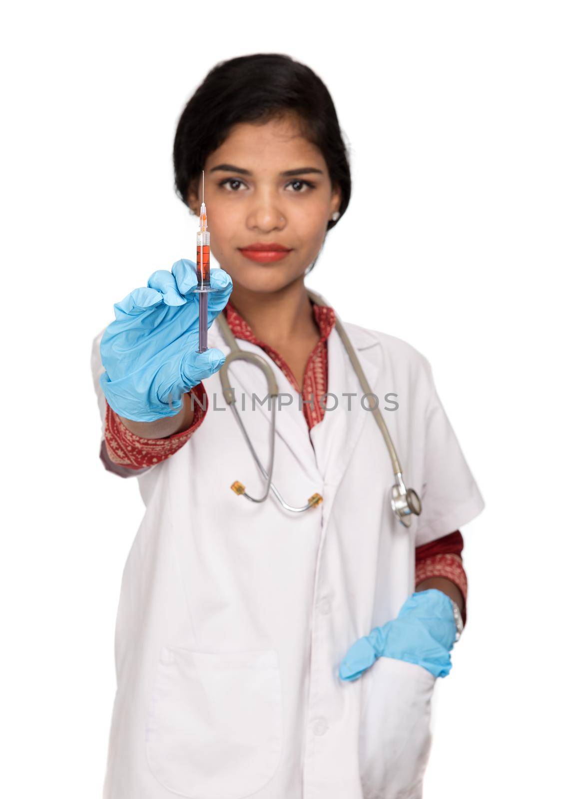 A female doctor with a stethoscope is holding an Injection or Syringe.