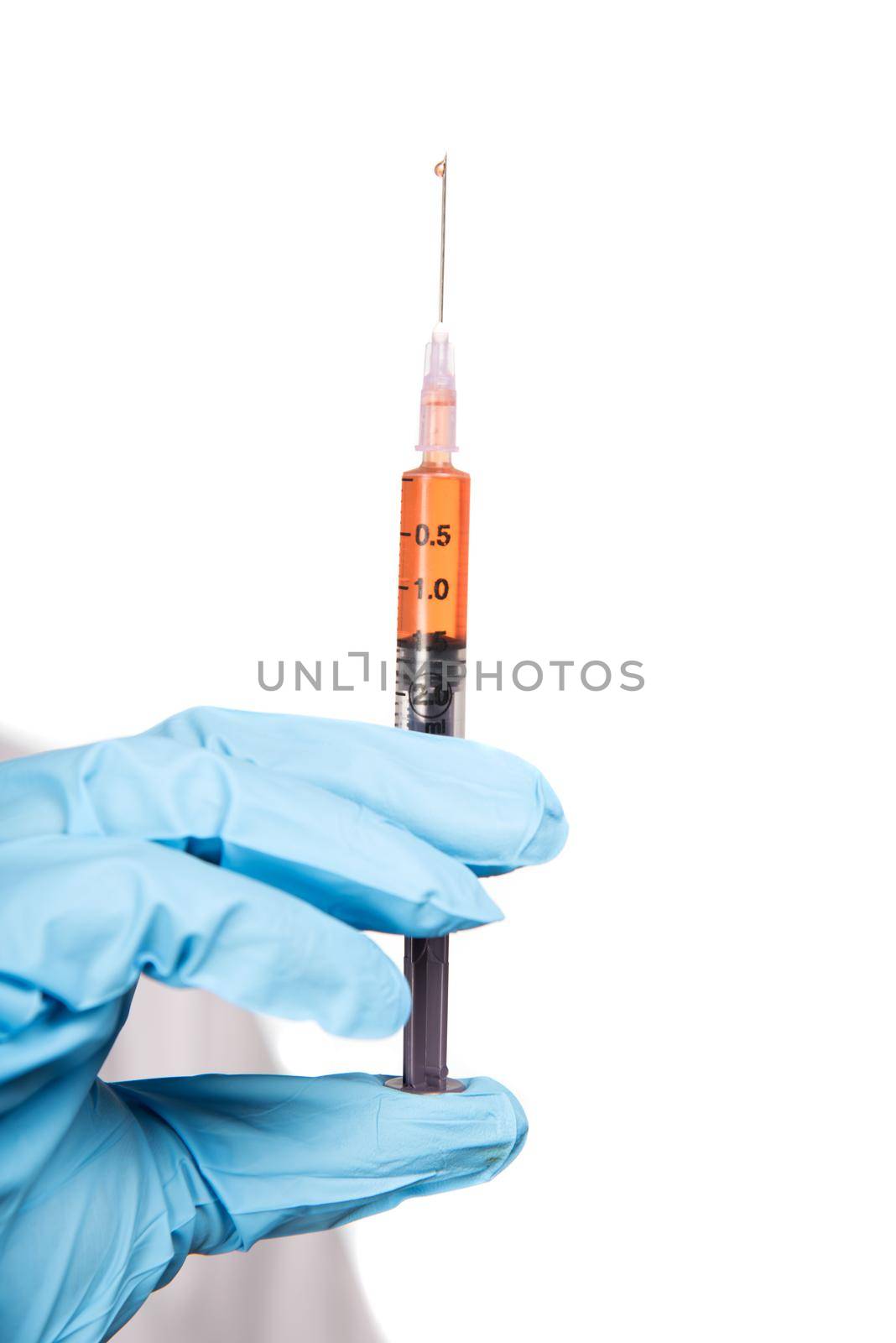 A female doctor with a stethoscope is holding an Injection or Syringe.