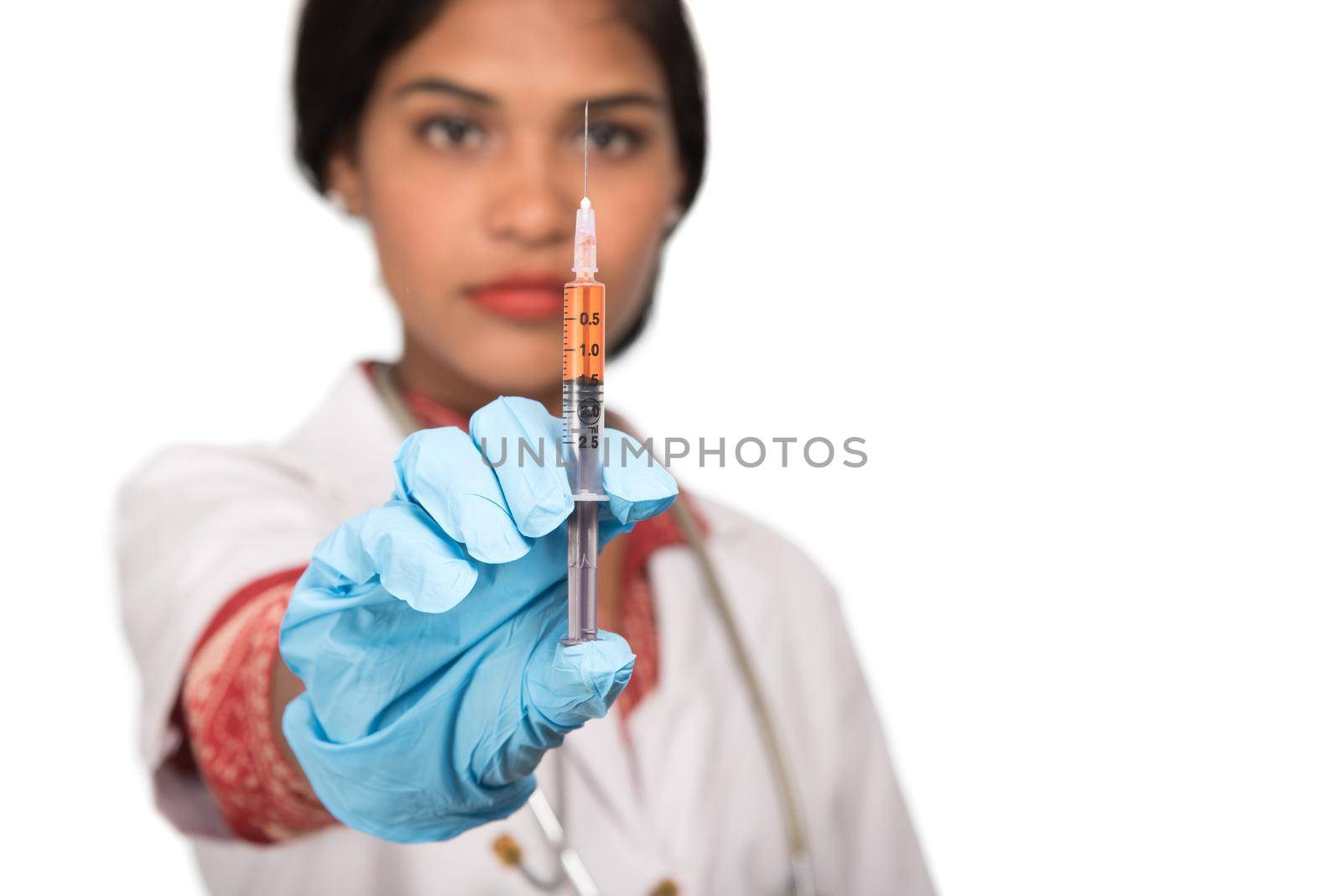 A female doctor with a stethoscope is holding an Injection or Syringe.