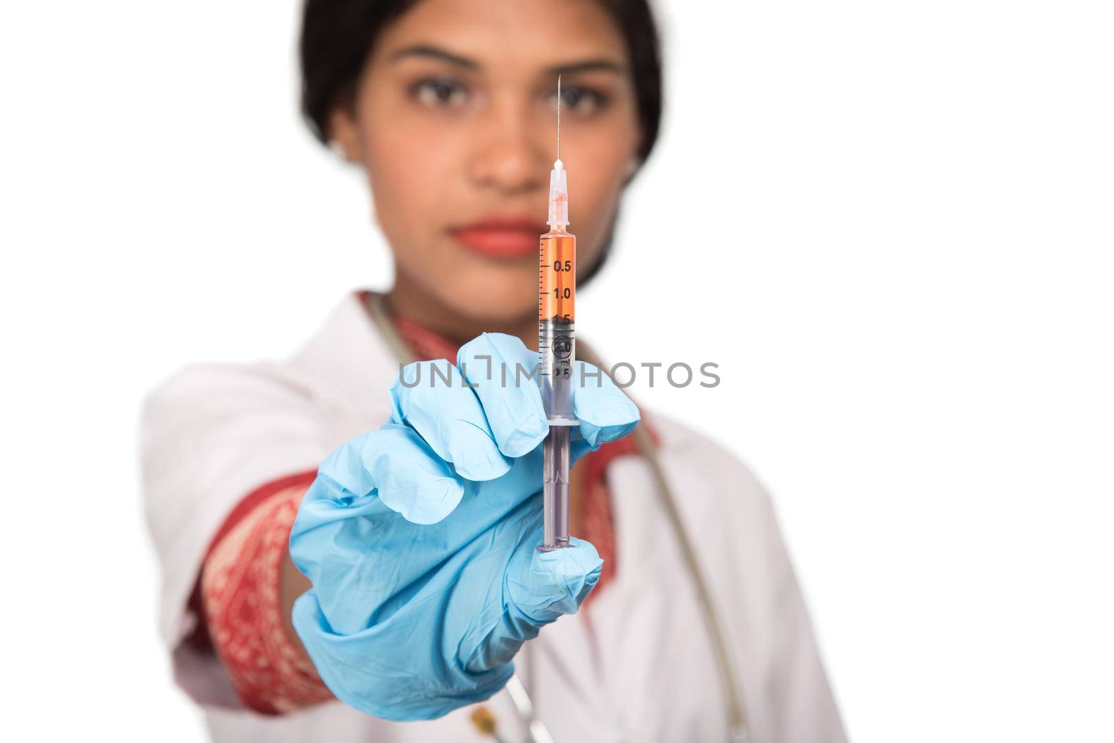 A female doctor with a stethoscope is holding an Injection or Syringe.