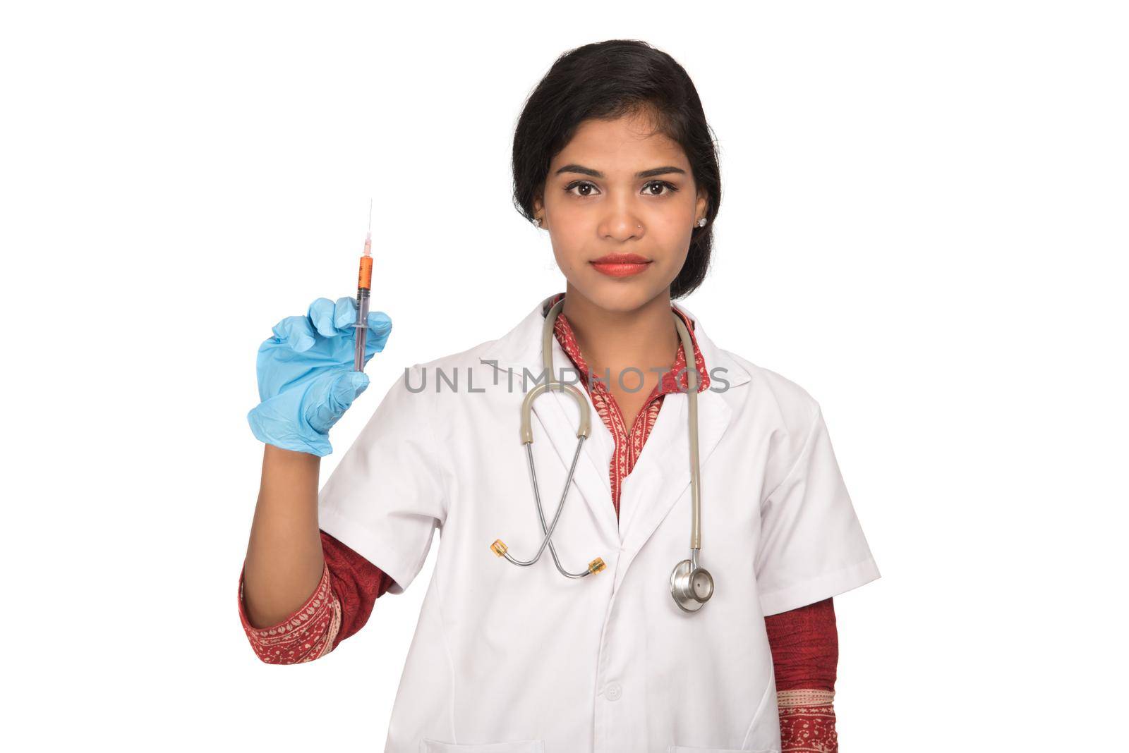 A female doctor with a stethoscope is holding an Injection or Syringe.