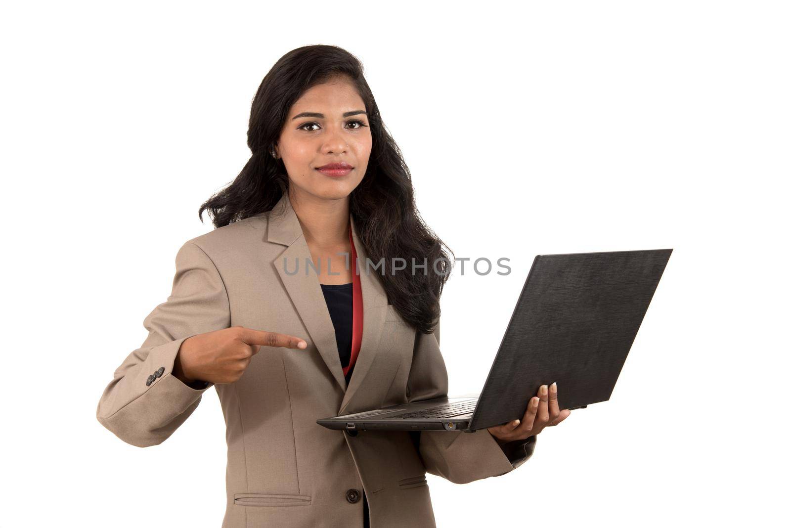 Happy excited business woman holding laptop and pointing on it isolated on a white background