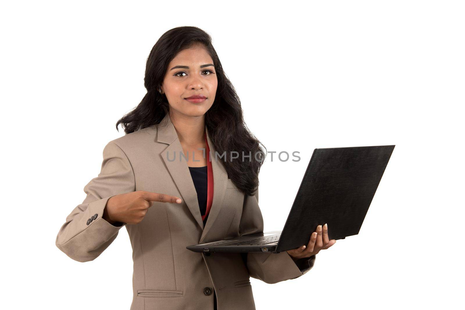 Happy excited business woman holding laptop and pointing on it isolated on a white background