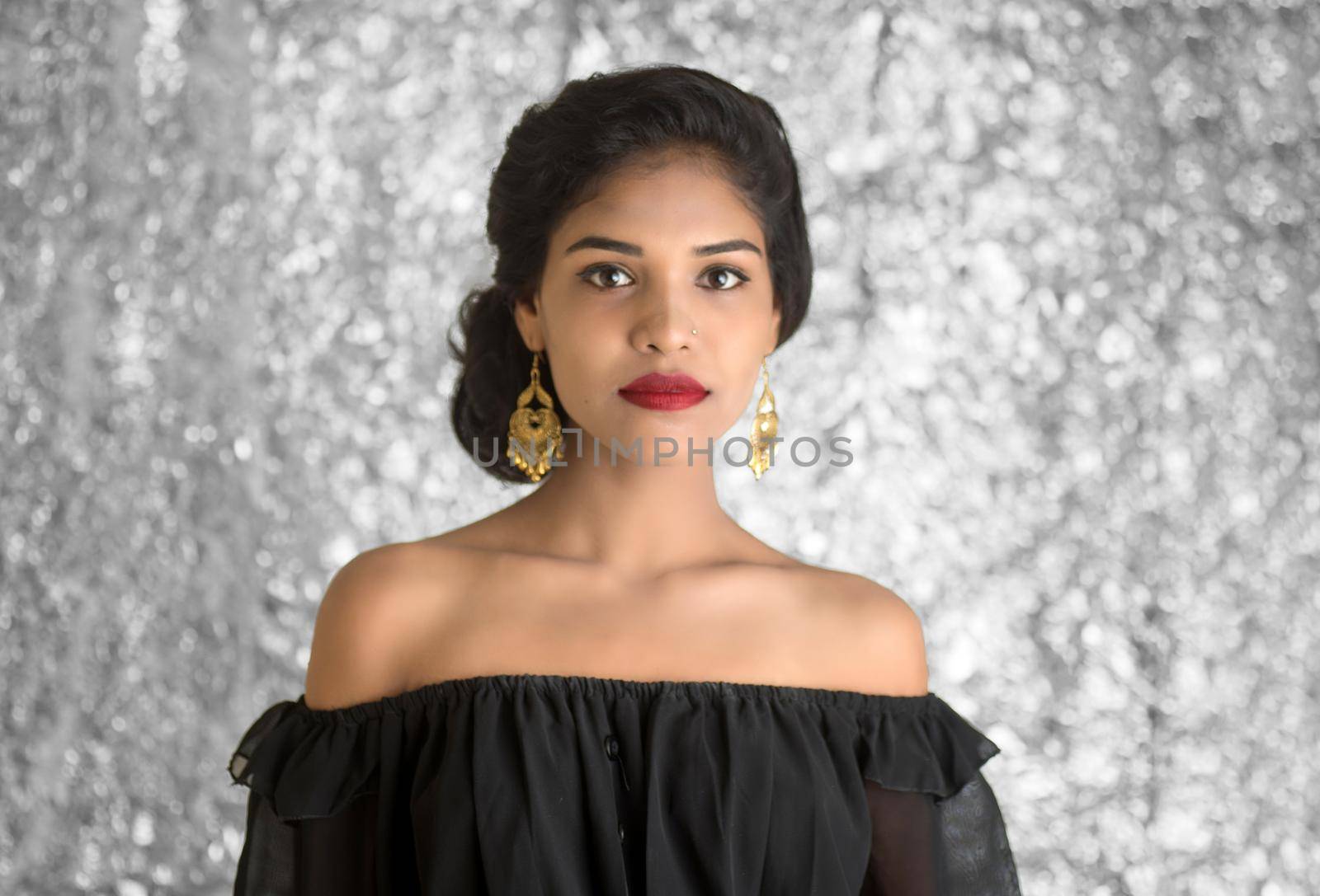 Portrait of beautiful young Girl. Closeup face of a pretty Indian model on texture background