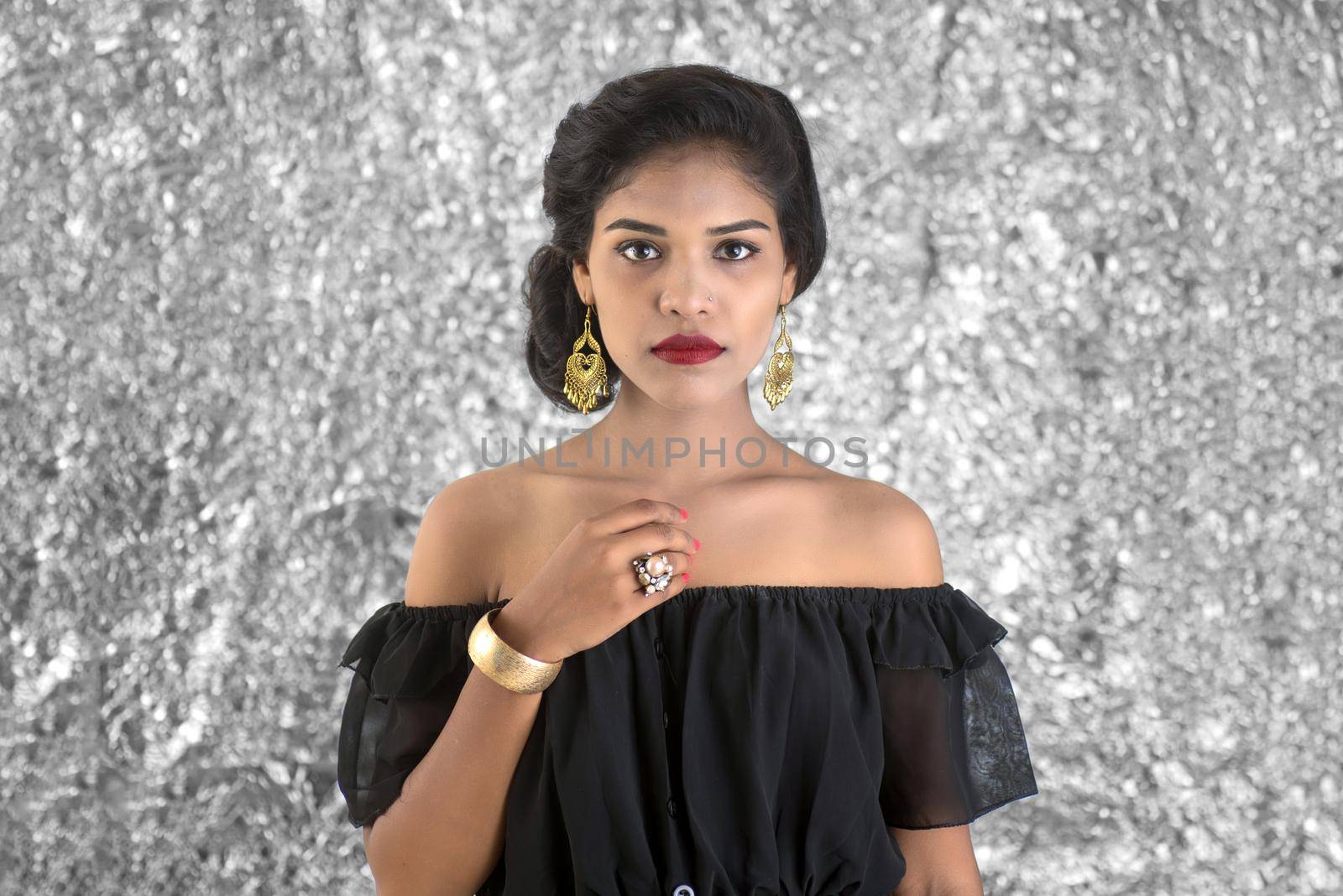 Portrait of beautiful young Girl. Closeup face of a pretty Indian model on texture background by DipakShelare