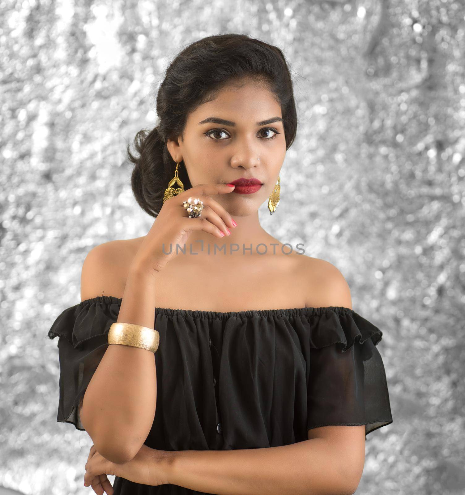 Portrait of beautiful young Girl. Closeup face of a pretty Indian model on texture background by DipakShelare