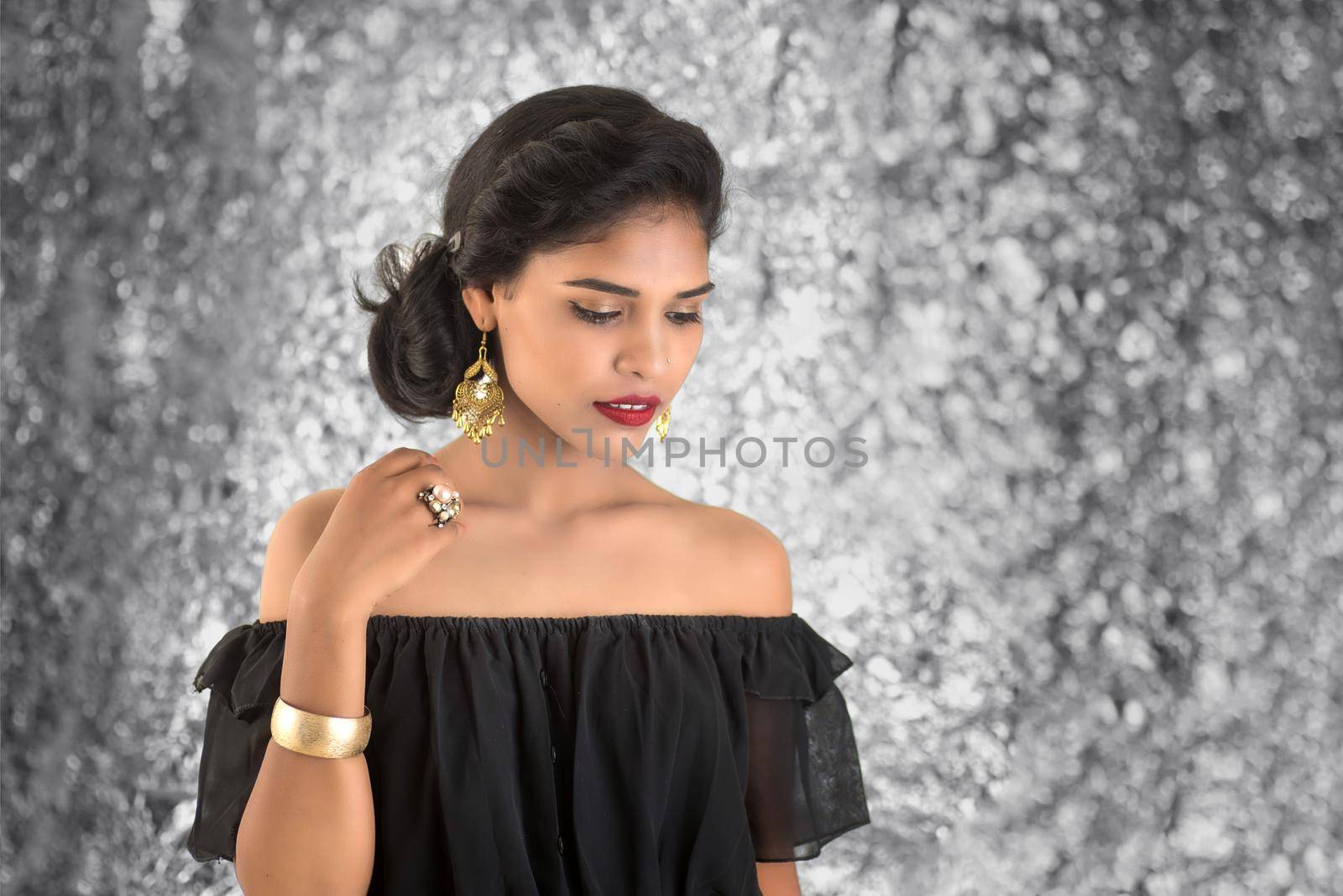 Portrait of beautiful young Girl. Closeup face of a pretty Indian model on texture background