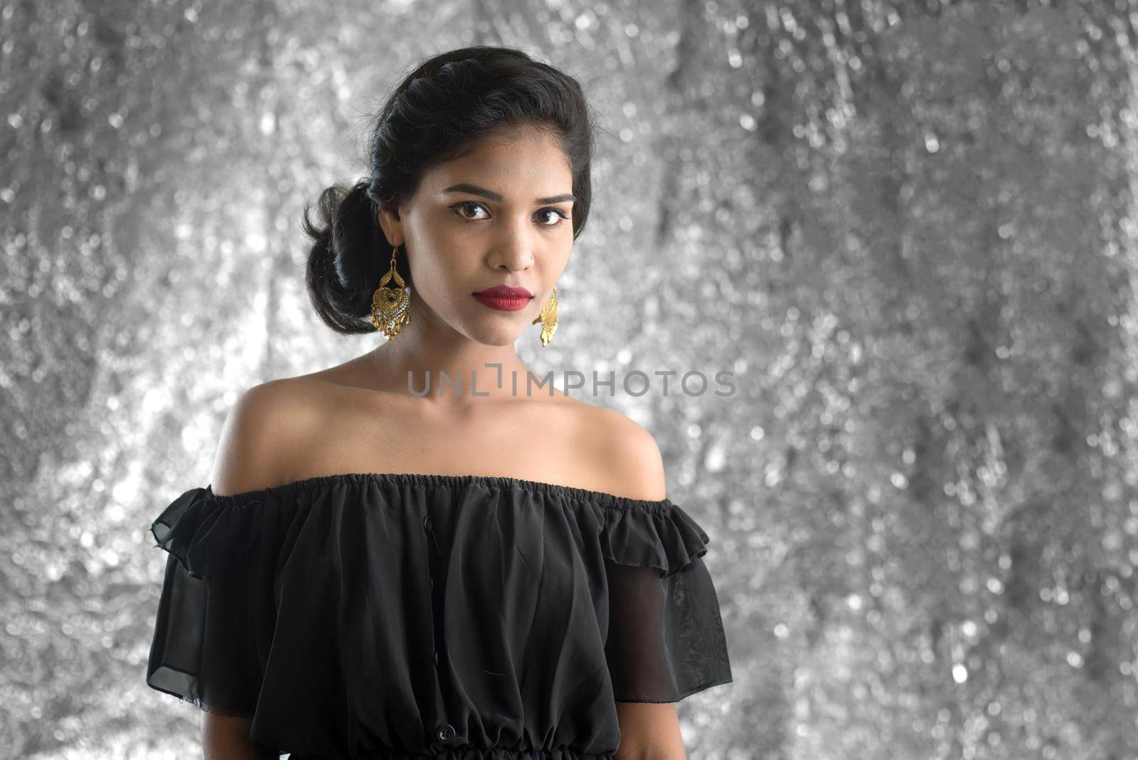 Portrait of beautiful young Girl. Closeup face of a pretty Indian model on texture background by DipakShelare