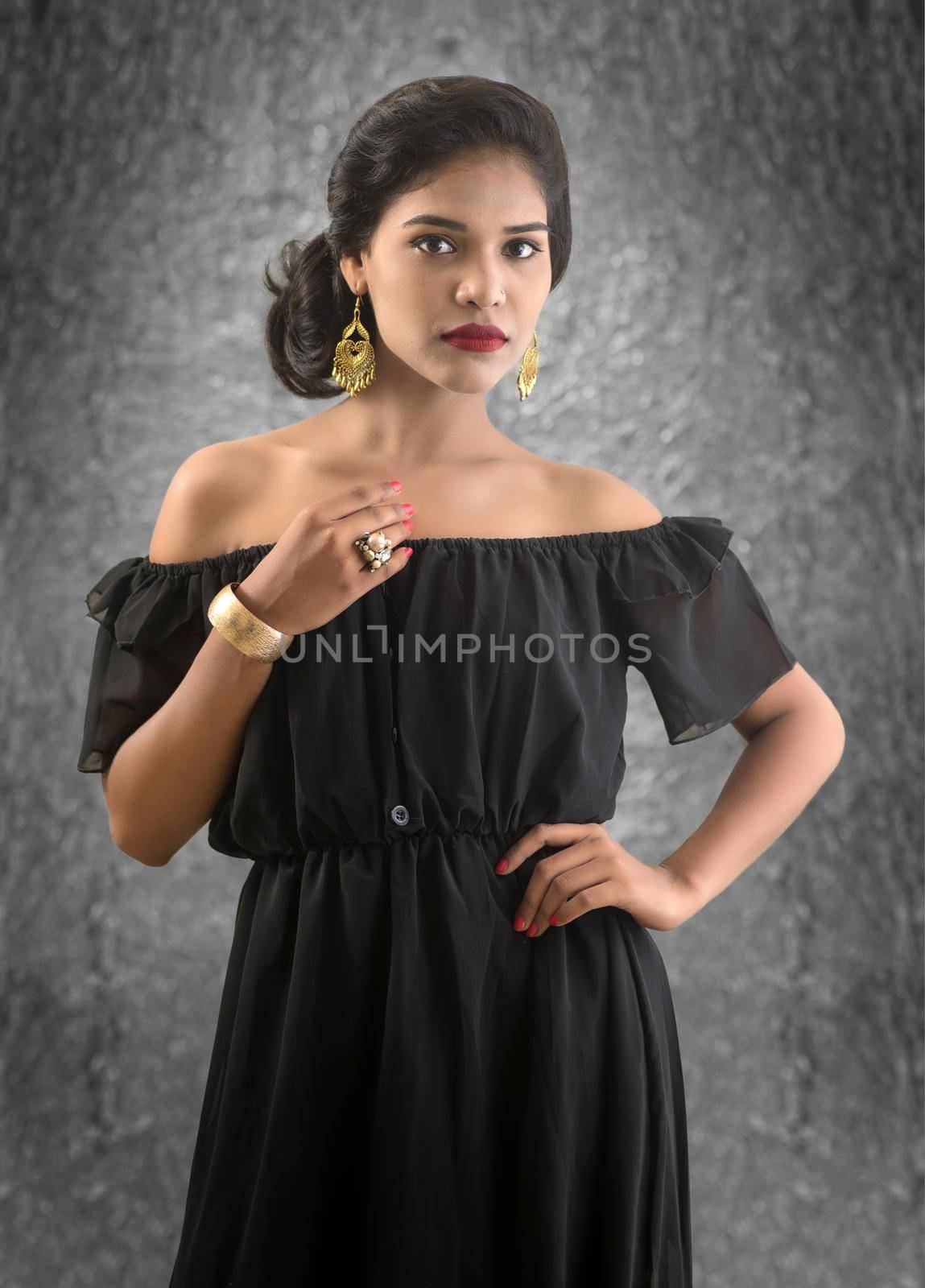 Portrait of beautiful young Girl. Closeup face of a pretty Indian model on texture background by DipakShelare