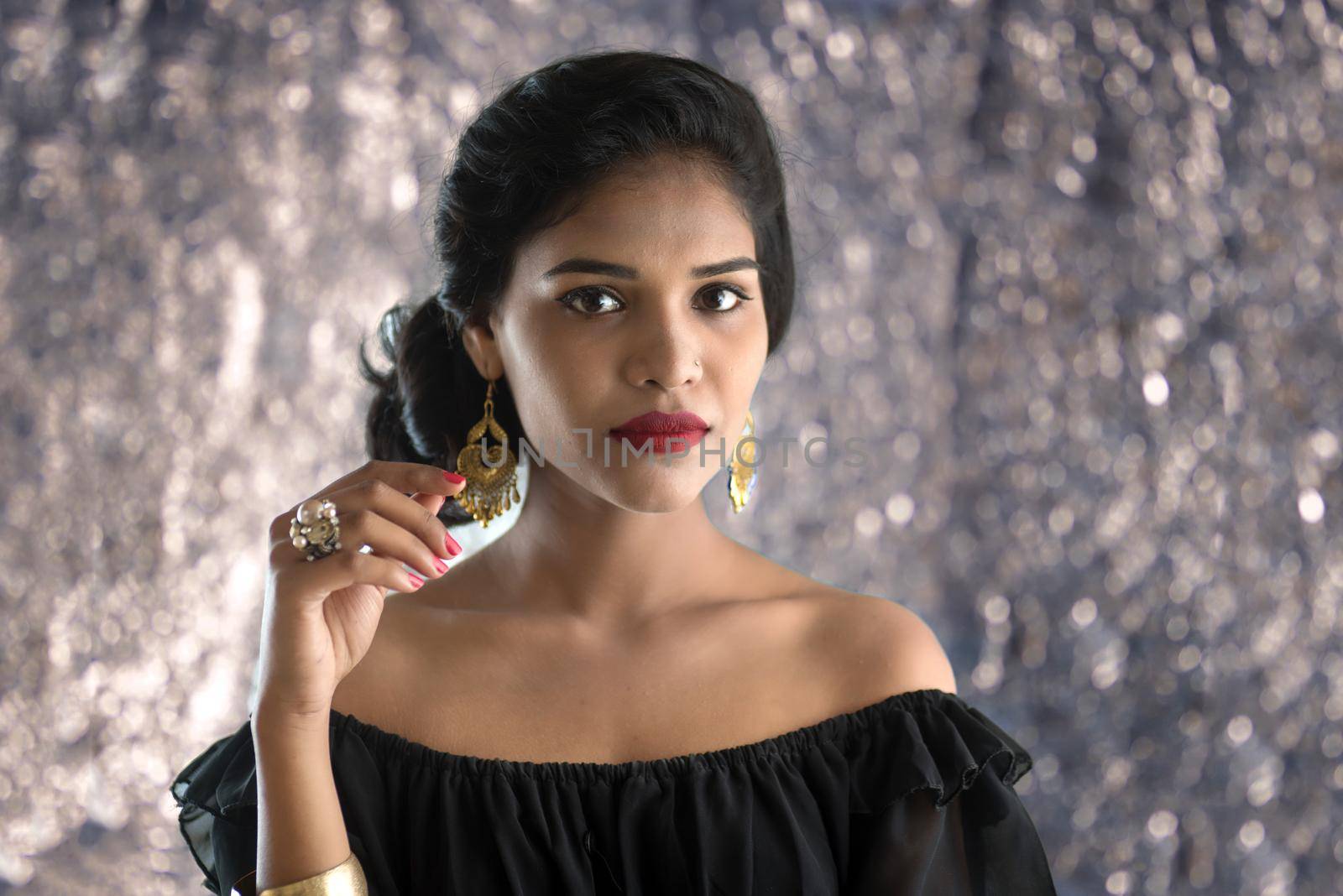 Portrait of beautiful young Girl. Closeup face of a pretty Indian model on texture background