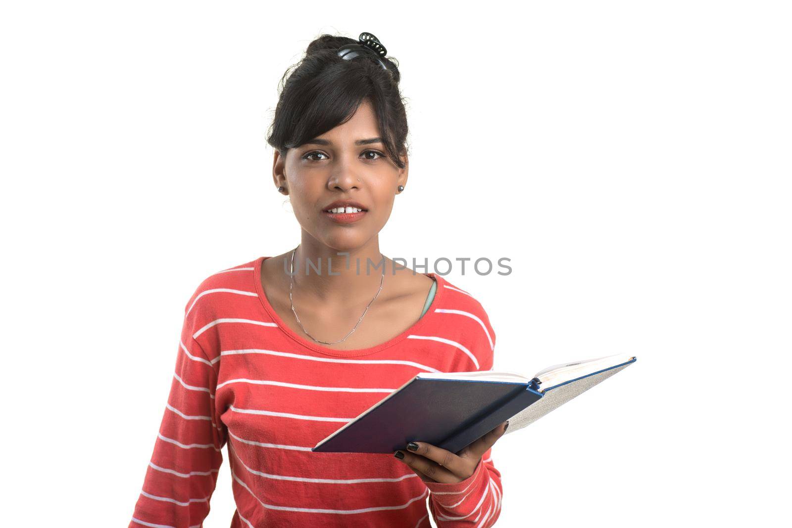 Pretty young girl holding book and posing on white background