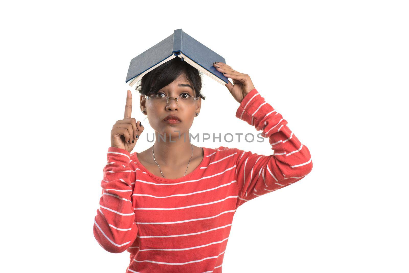 Pretty young girl holding book and posing on white background