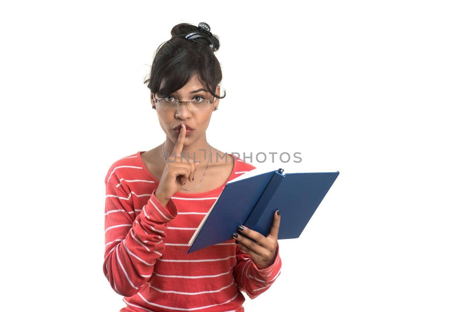 Pretty young girl holding book and posing on white background