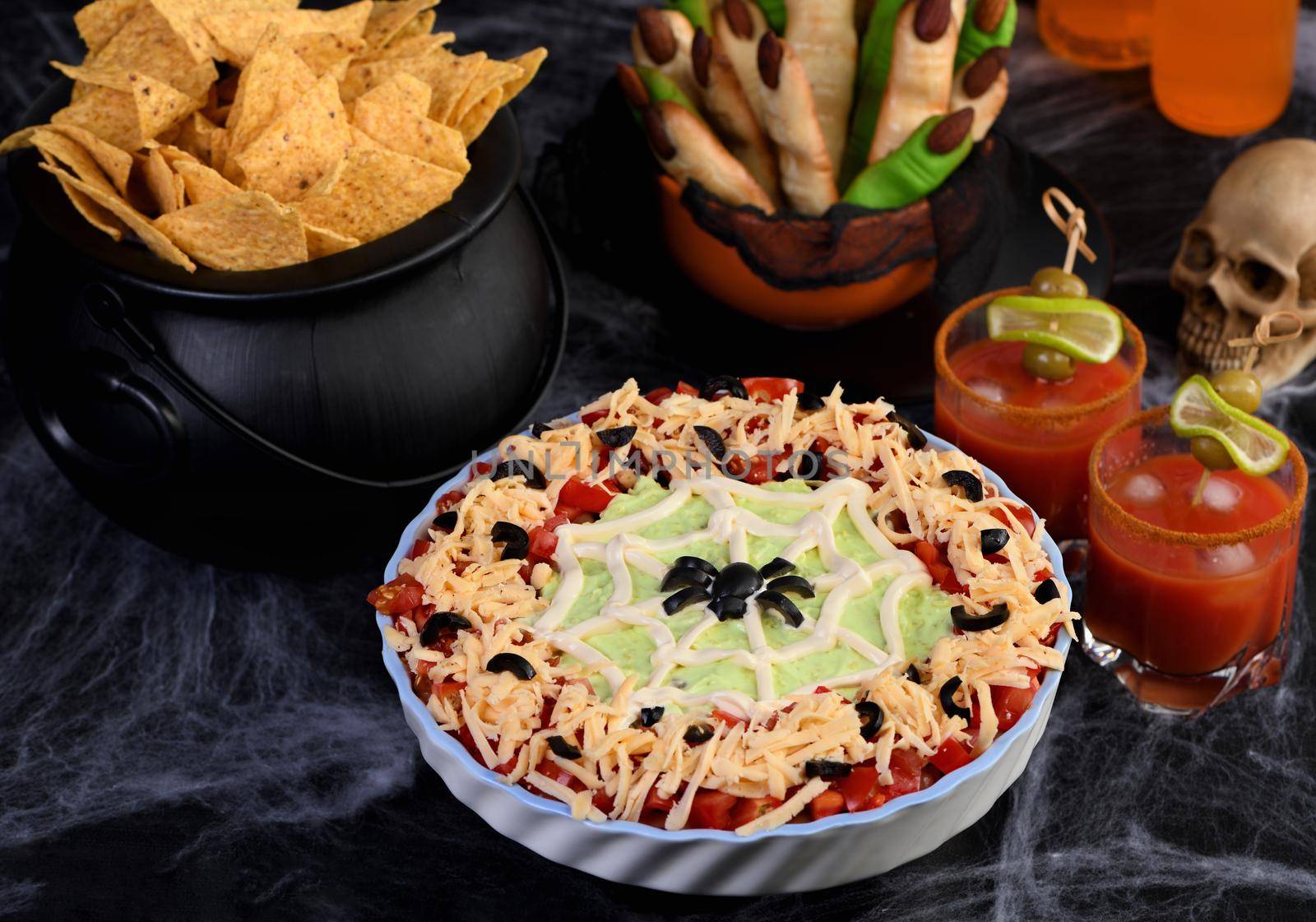 Spooky Halloween Seven Layer Taco Dip: Turn a classic appetizer into a Halloween with of black olive spider .