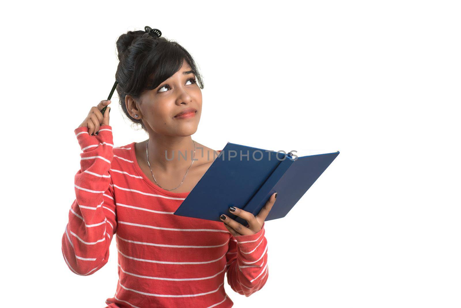 Pretty young girl holding book and posing on white background