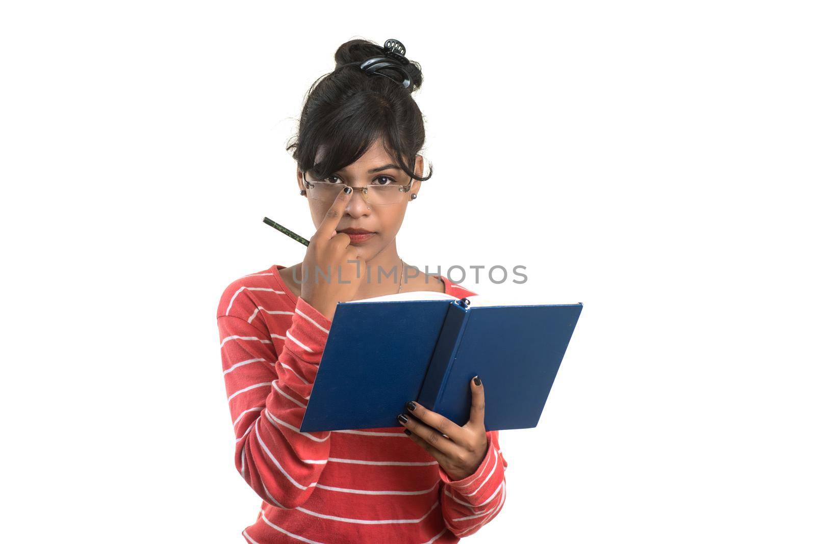 Pretty young girl holding book and posing on white background