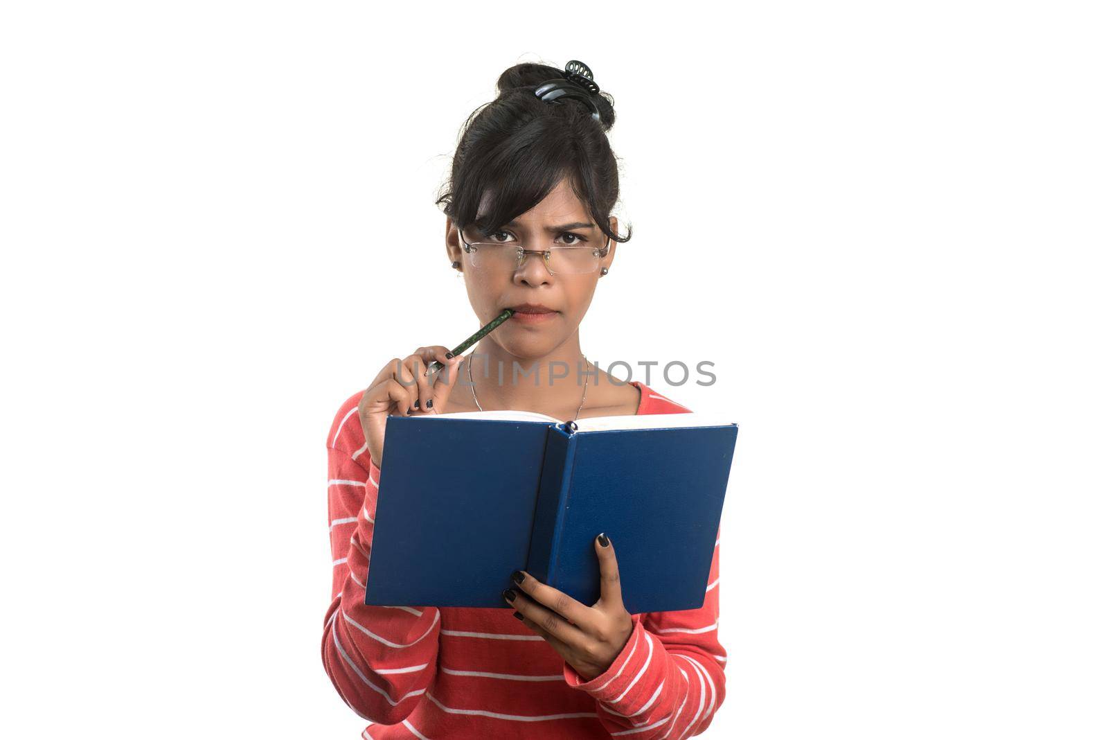 Pretty young girl holding book and posing on white background