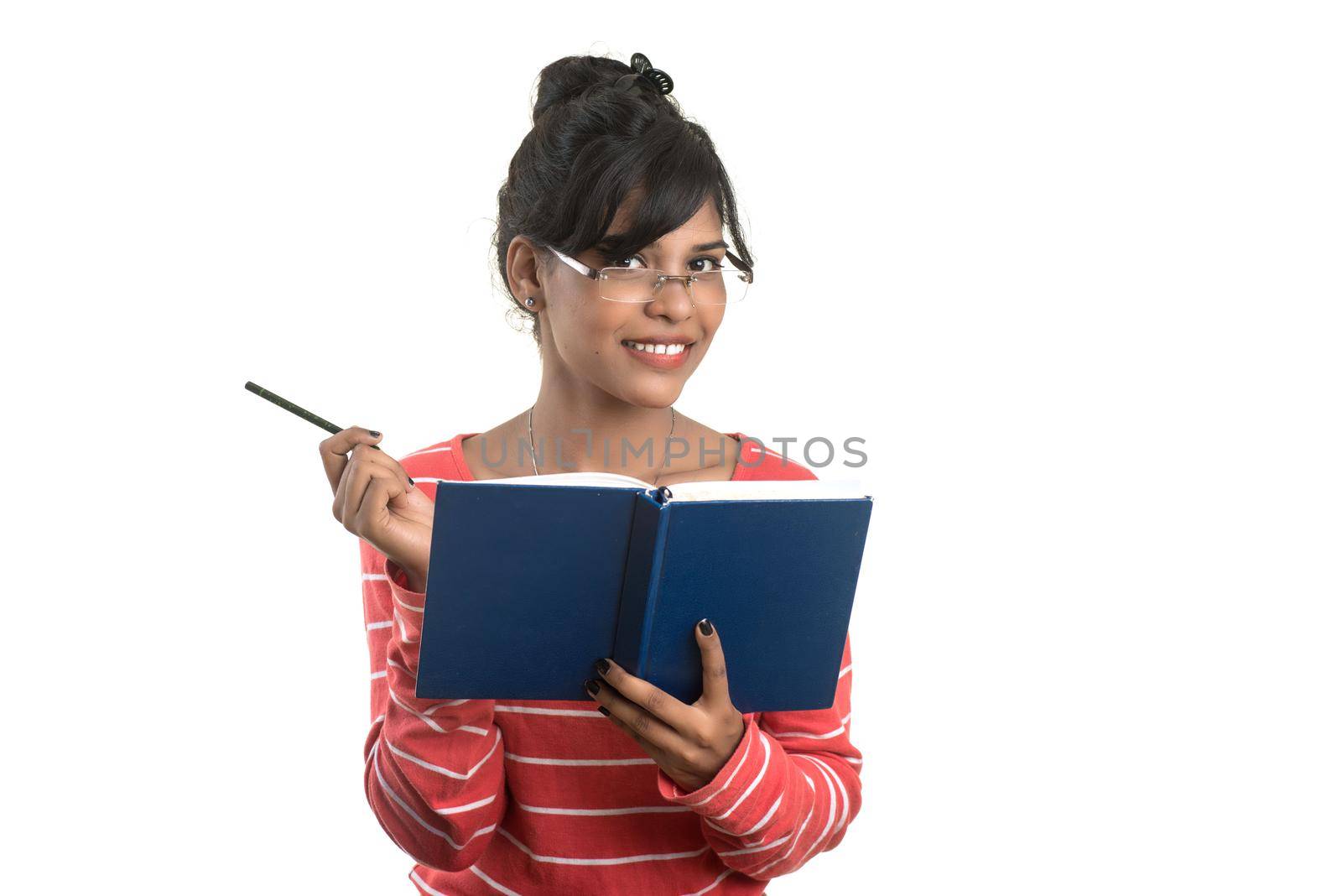 Pretty young girl holding book and posing on white background