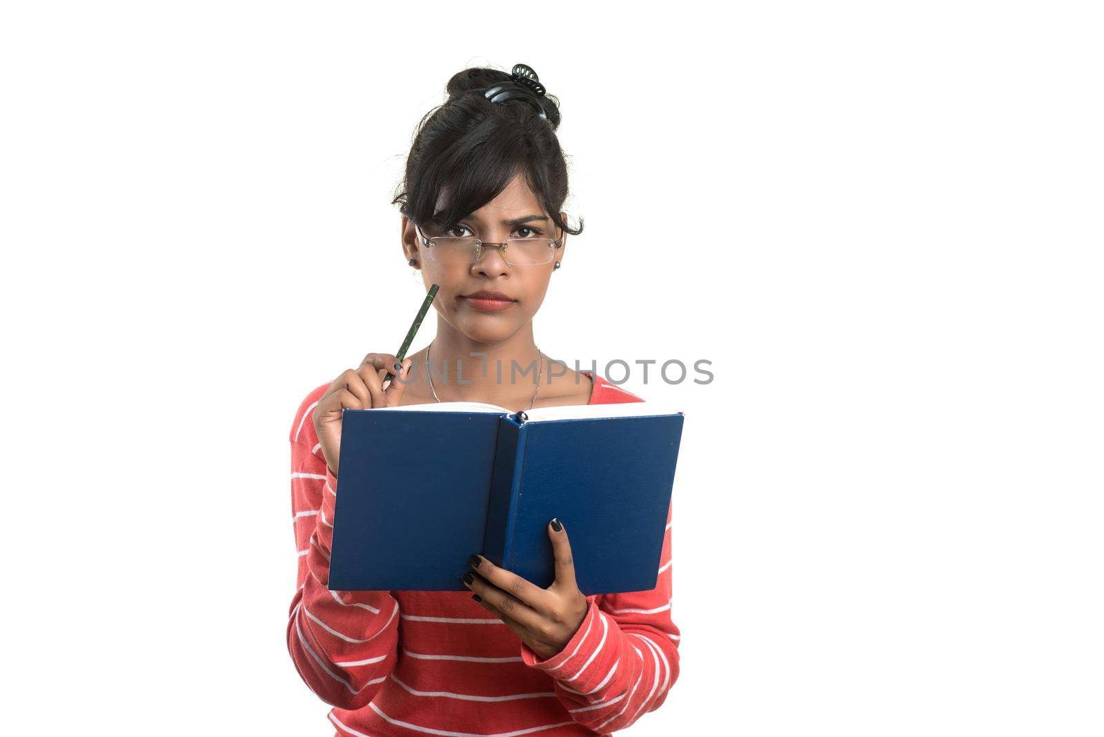 Pretty young girl holding book and posing on white background by DipakShelare