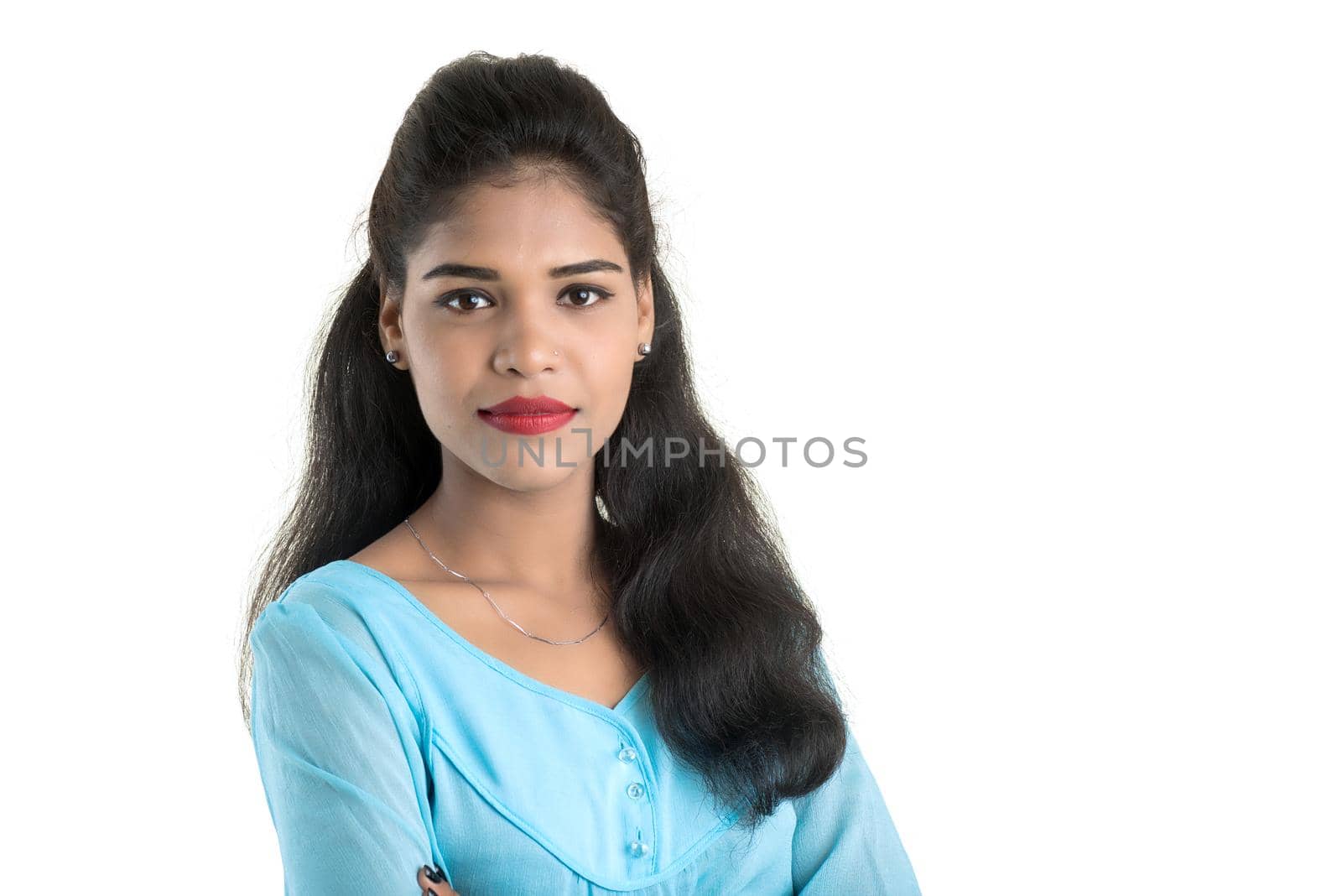 Portrait of beautiful young smiling girl posing on white background