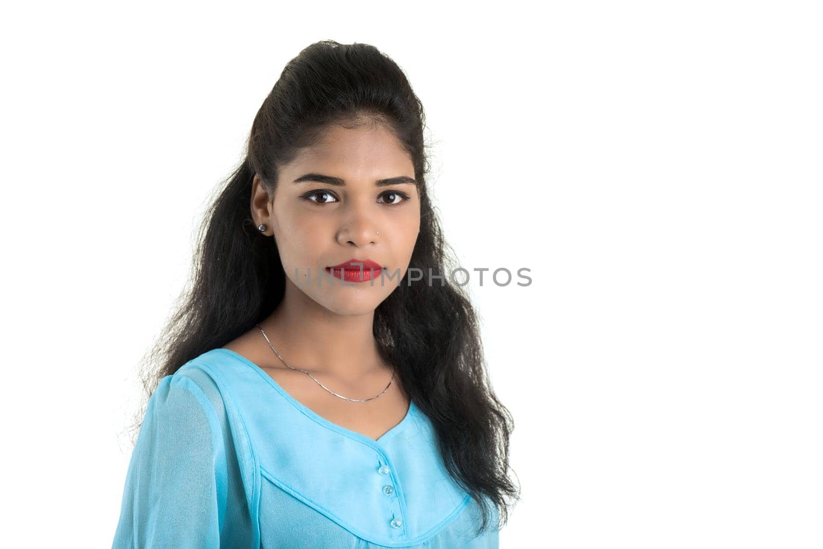 Portrait of beautiful young smiling girl posing on white background