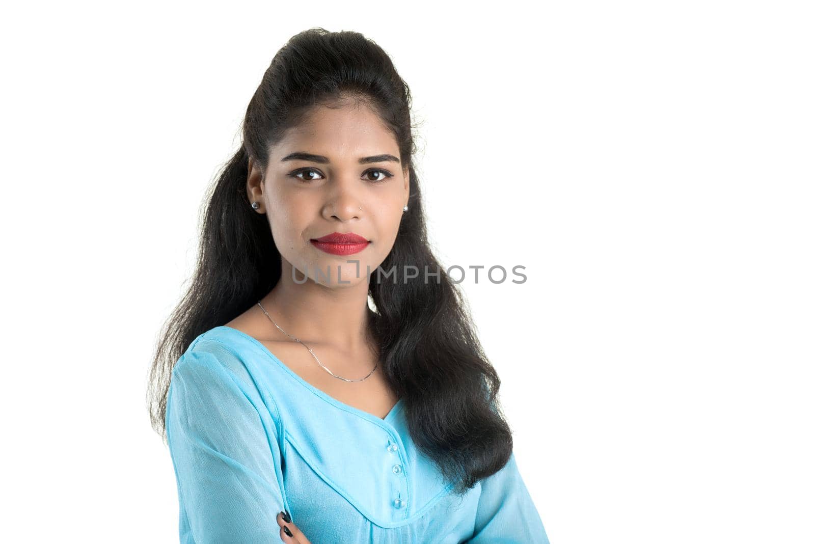 Portrait of beautiful young smiling girl posing on white background