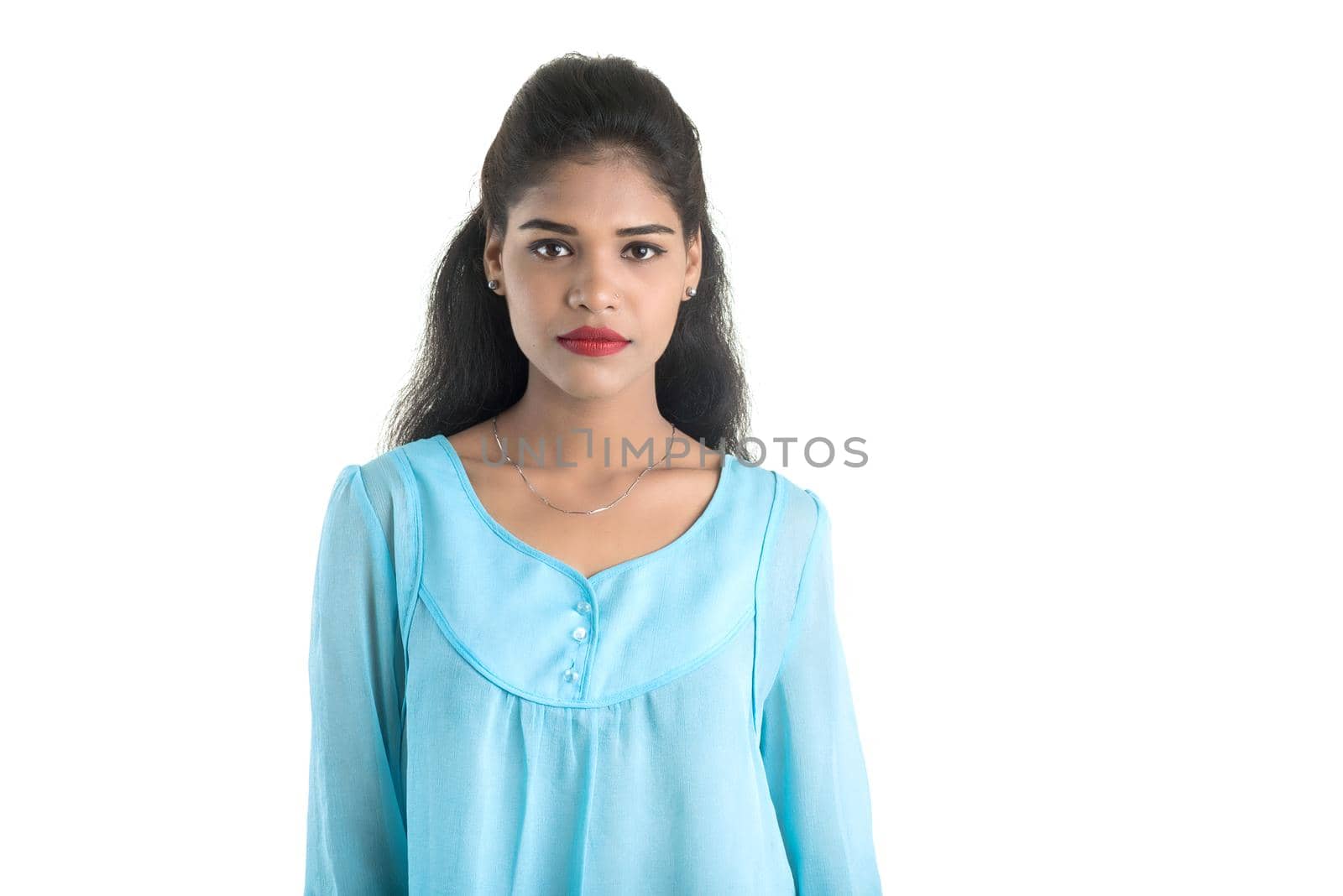 Portrait of beautiful young smiling girl posing on white background