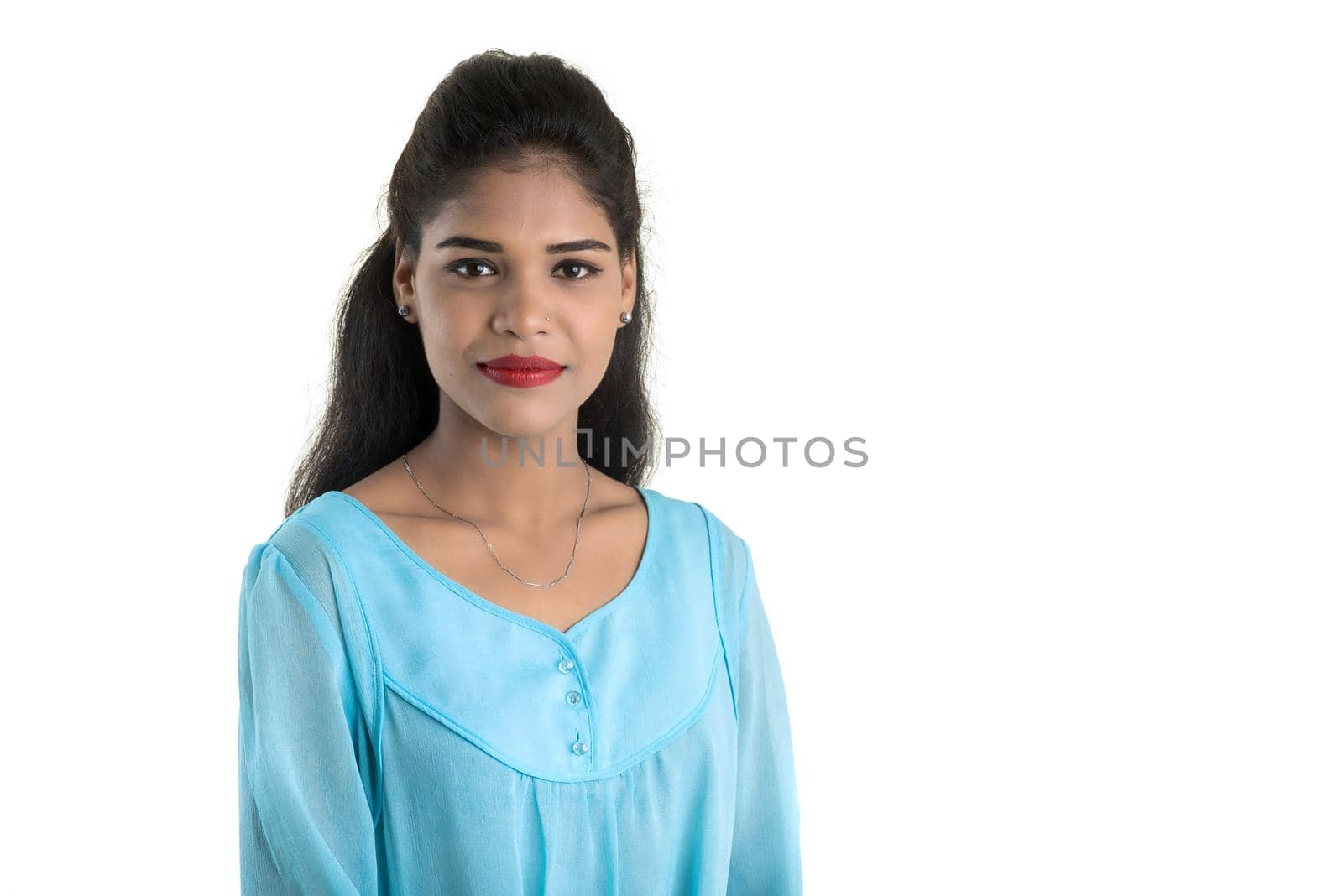 Portrait of beautiful young smiling girl posing on white background