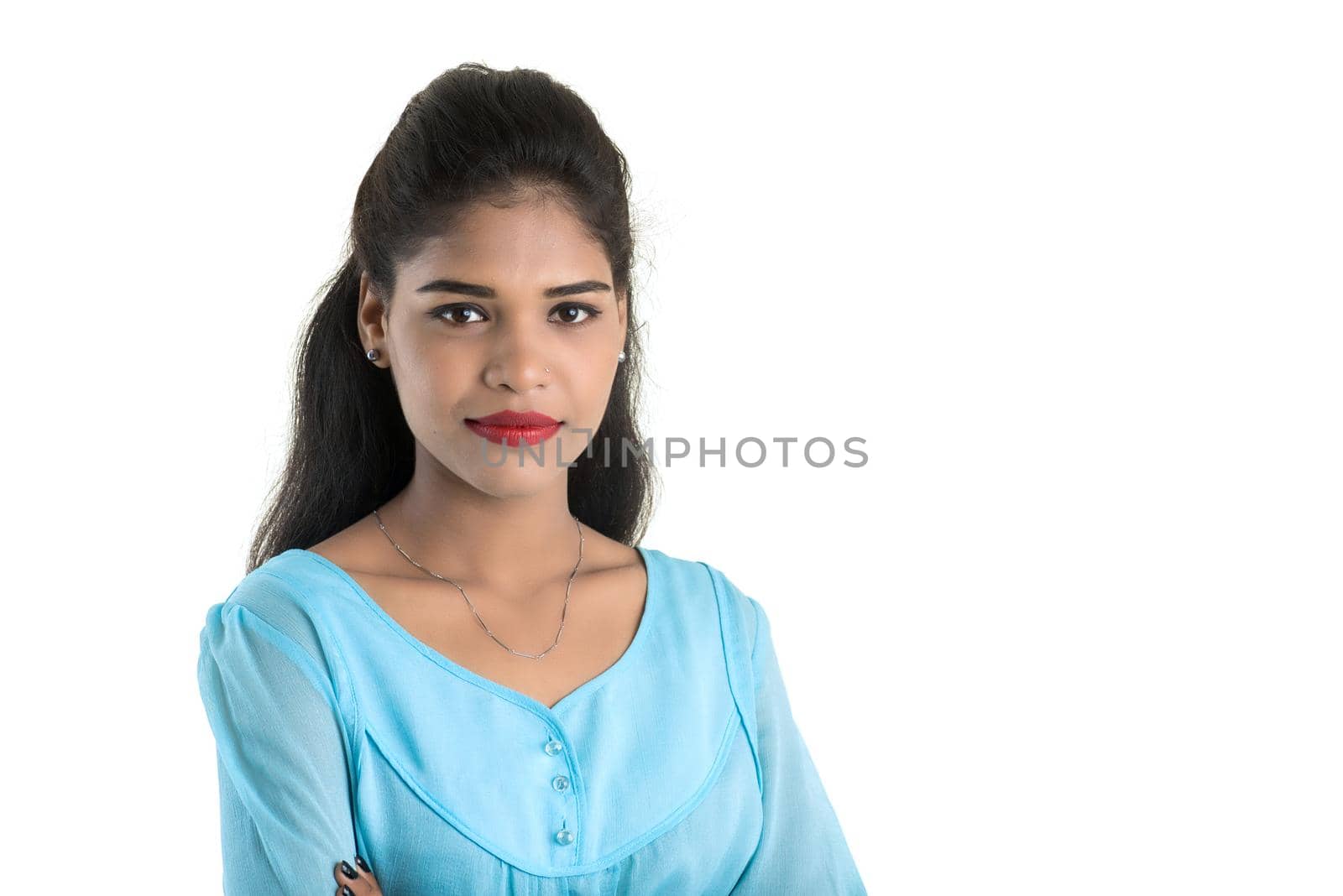 Portrait of beautiful young smiling girl posing on white background