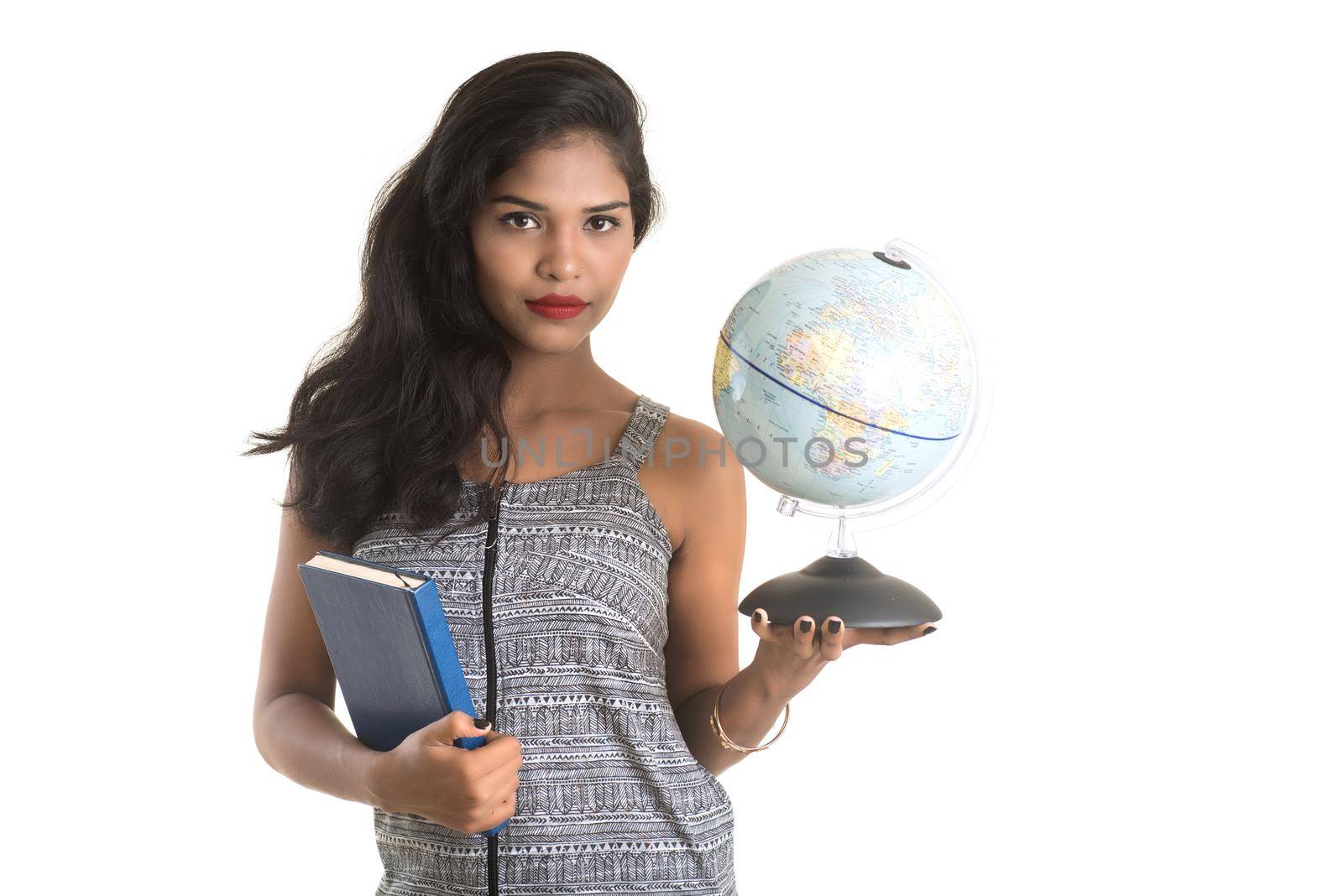 Young girl student holding book with globe on white background. Education in high school university college concept by DipakShelare