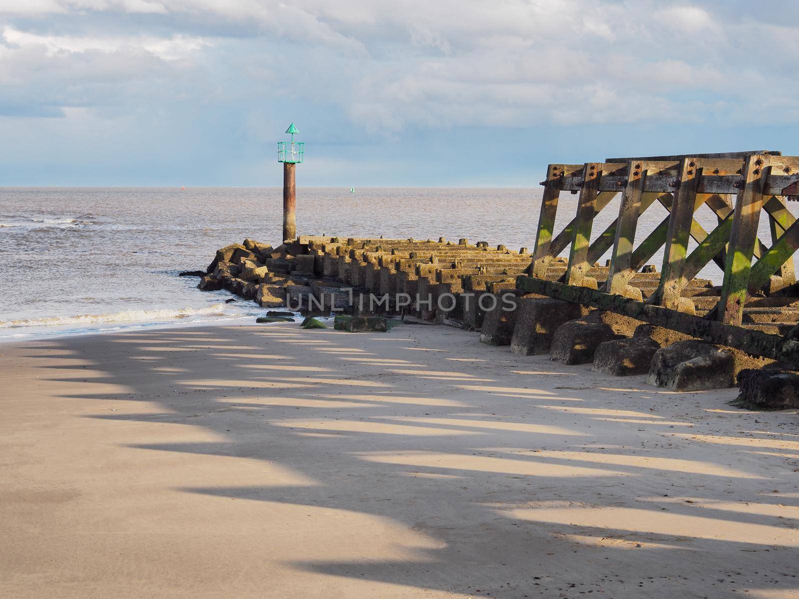 Derelict wooden railway jetty at Landguard Point at dusk, Felixstowe, Suffolk by PhilHarland