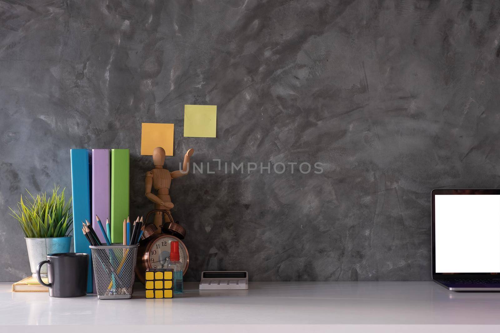 Cropped shot of workspace with mock-up laptop with white blank screen, Home interior or office background