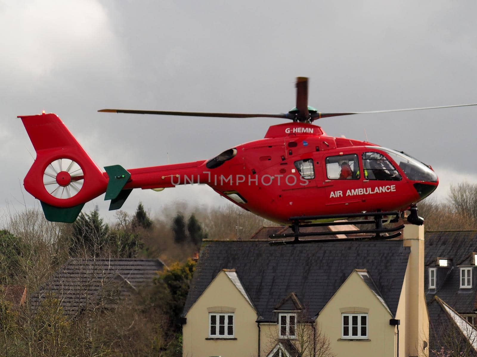 Aldermaston Wharf, Berkshire, UK, April 3 2018: Air Ambulance G-HEMN landing in a housing estate to attend to an emergency