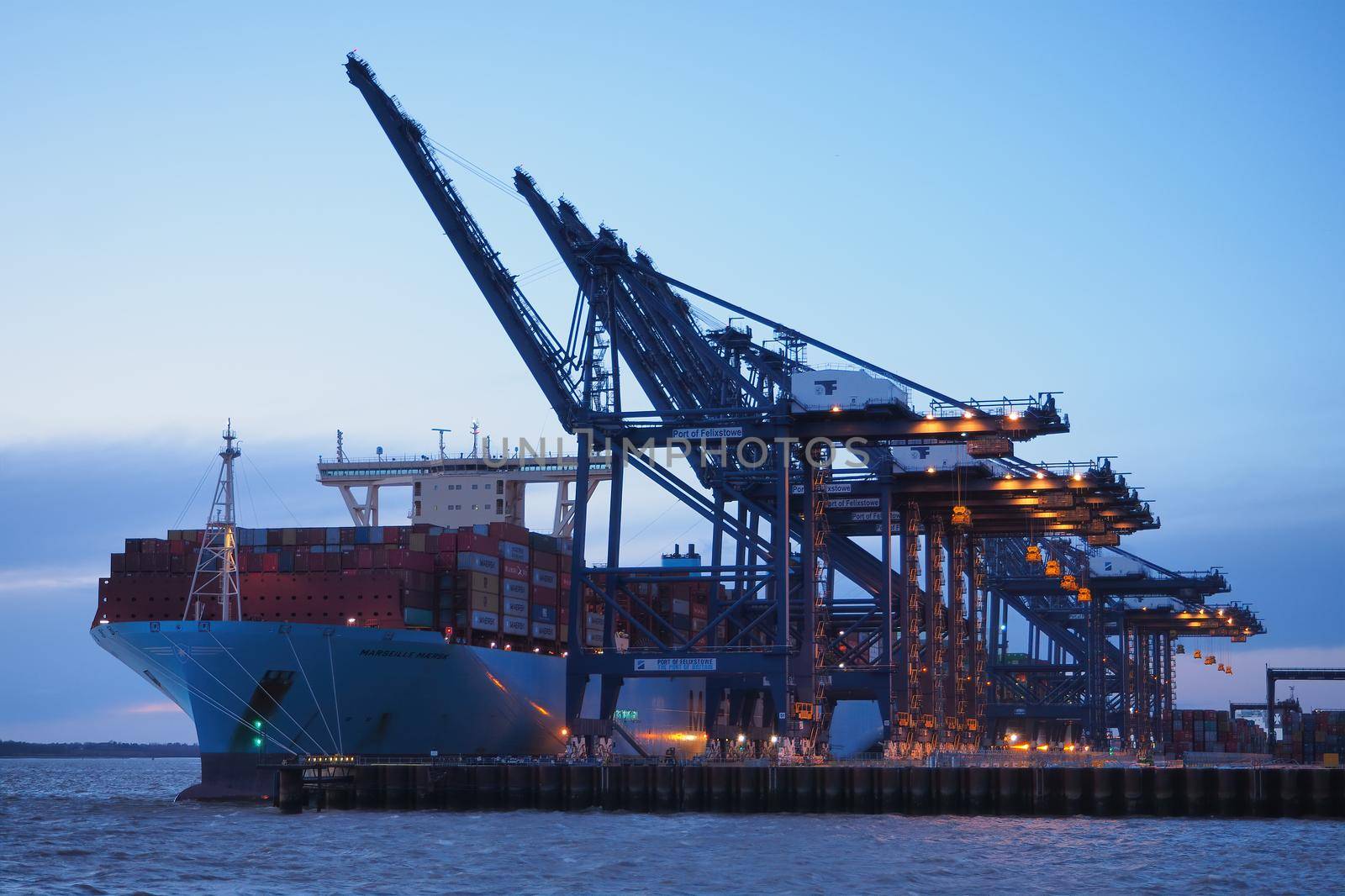 Port of Felixstowe, Suffolk, cranes loading containers to Marseille Maersk dusk by PhilHarland