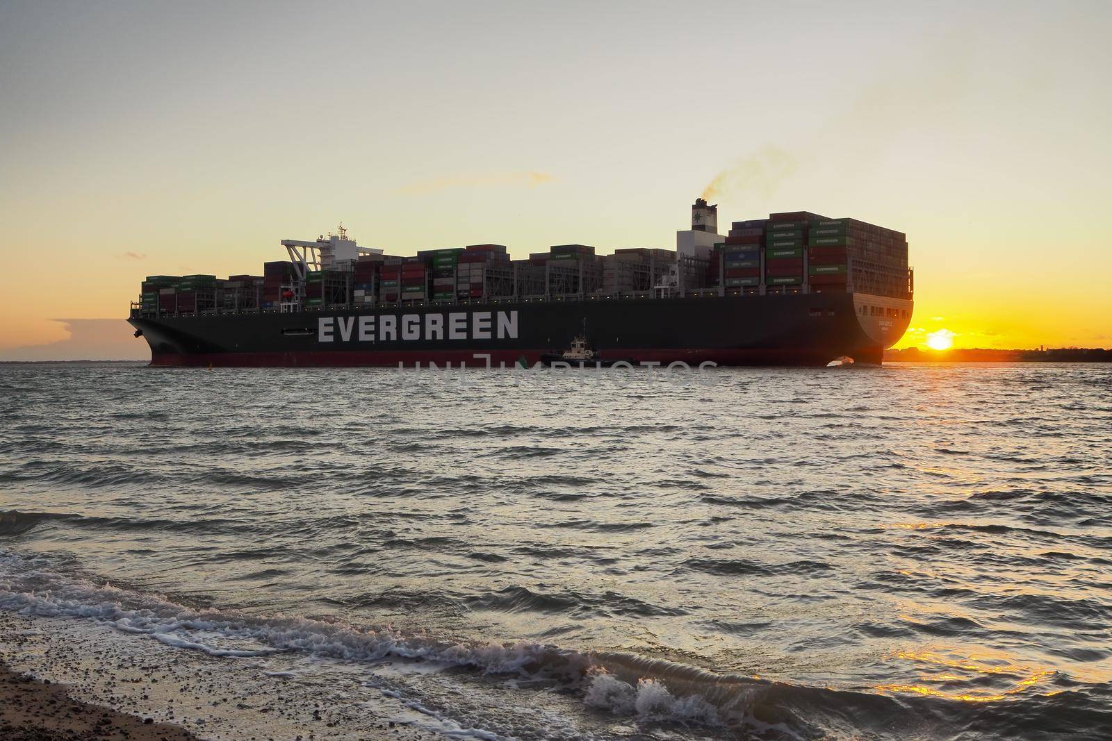 Port of Felixstowe, Suffolk, ship Ever Gentle with sun setting at stern at dusk by PhilHarland