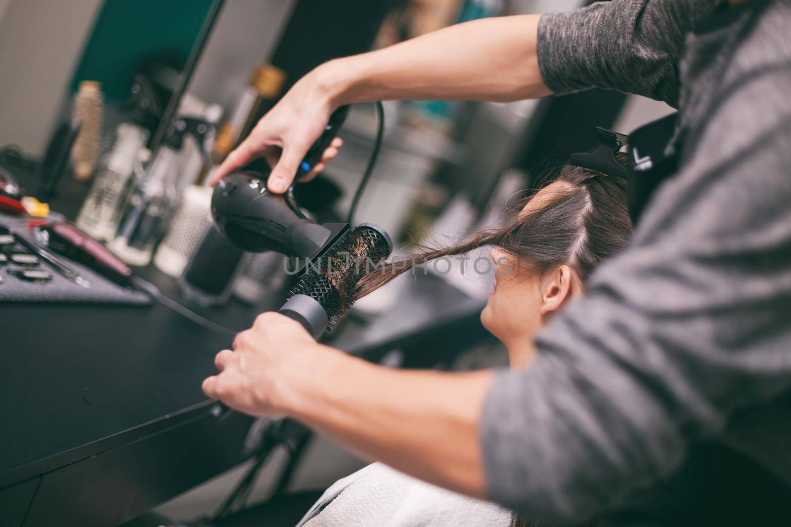 Young woman getting new hairstyle at professional hair styling saloon.