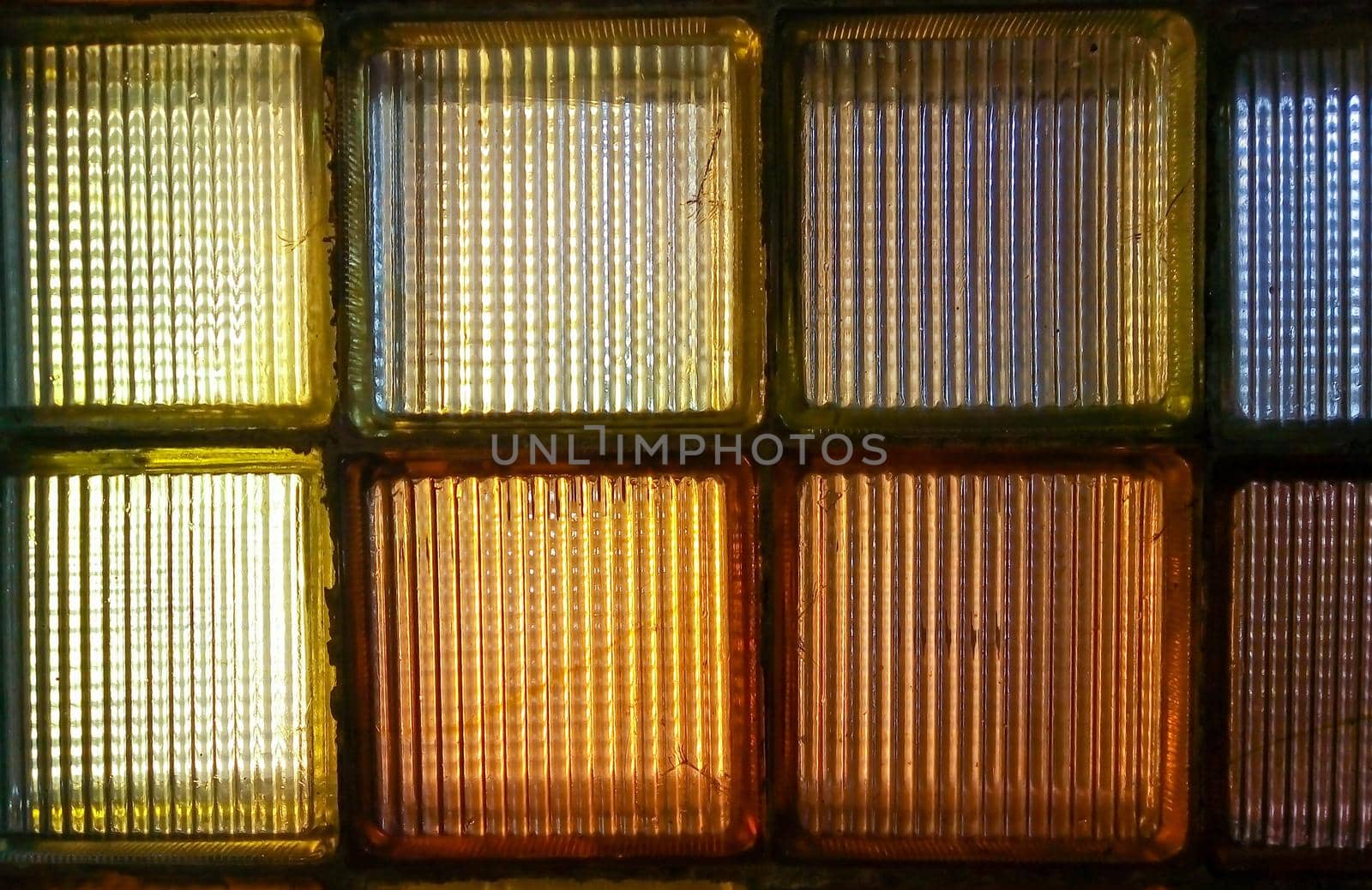 Old colored glass blocks with penetrating light, instead of a window.