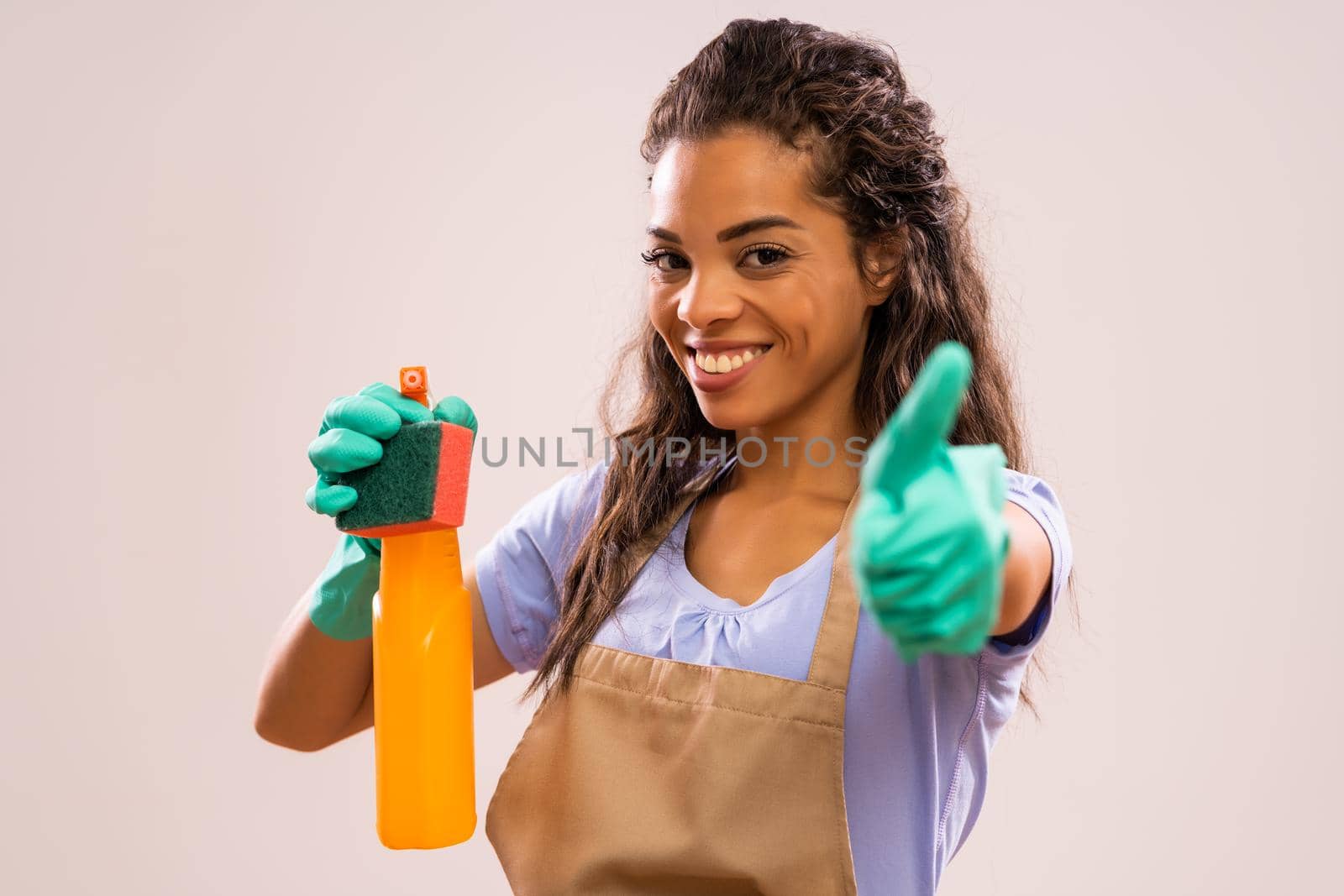 Portrait of happy and successful african-american housewife who is ready for housework.