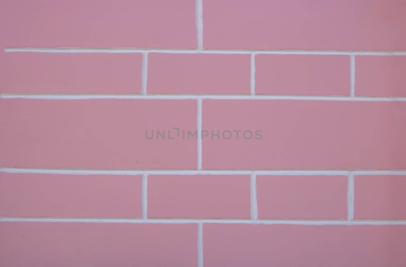 Pastel pink and white background texture of a plastered painted wall.