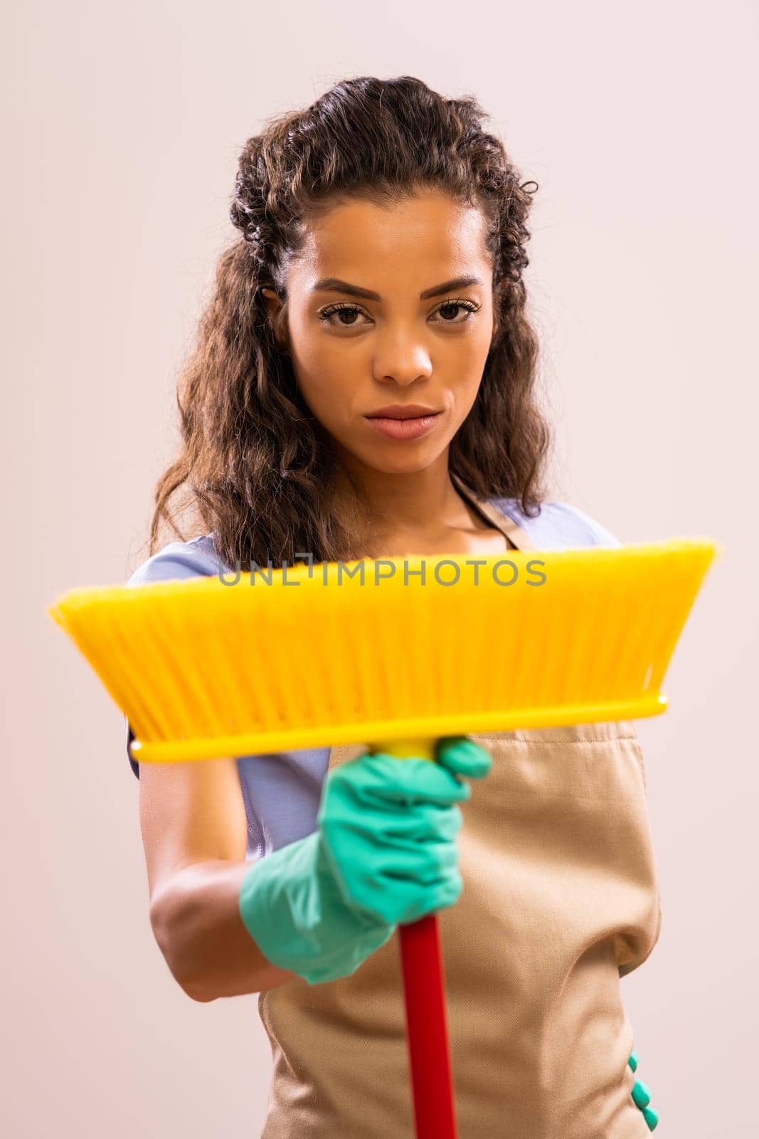 Portrait of african-american housewife who doesn't like cleaning.