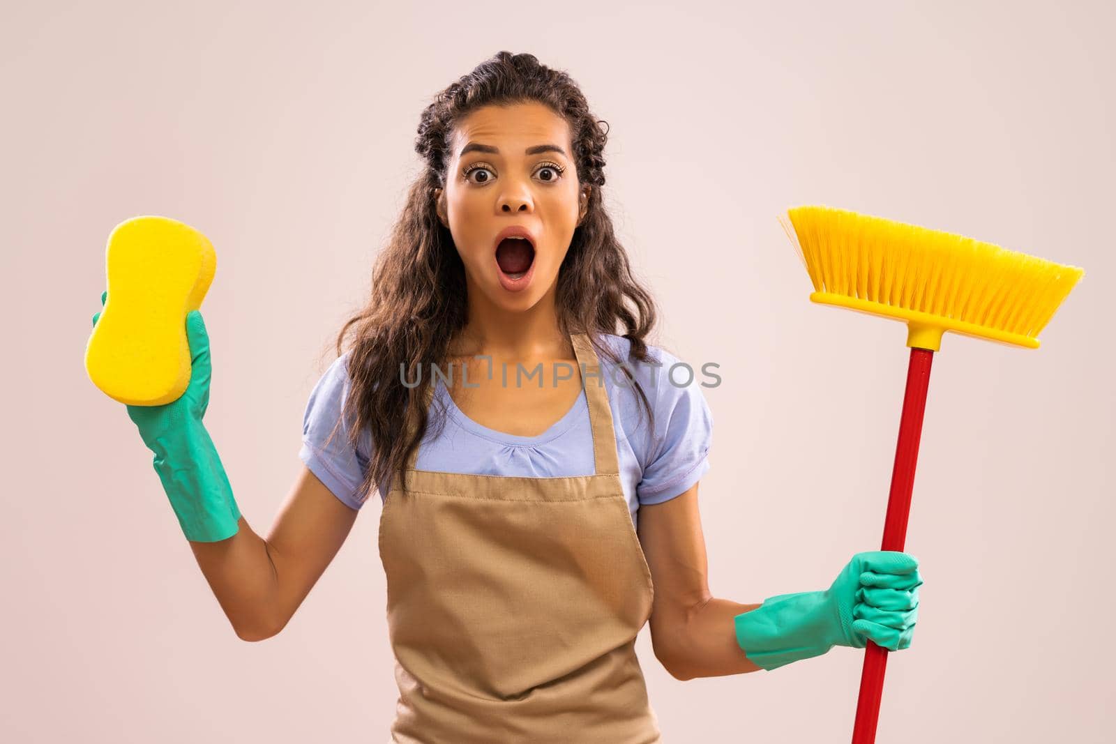 Portrait of african-american housewife who doesn't like cleaning.