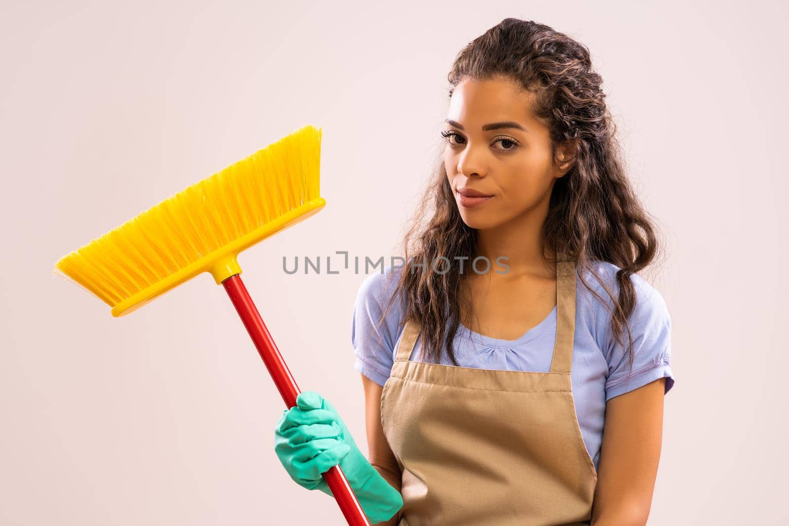 Portrait of african-american housewife who doesn't like cleaning.
