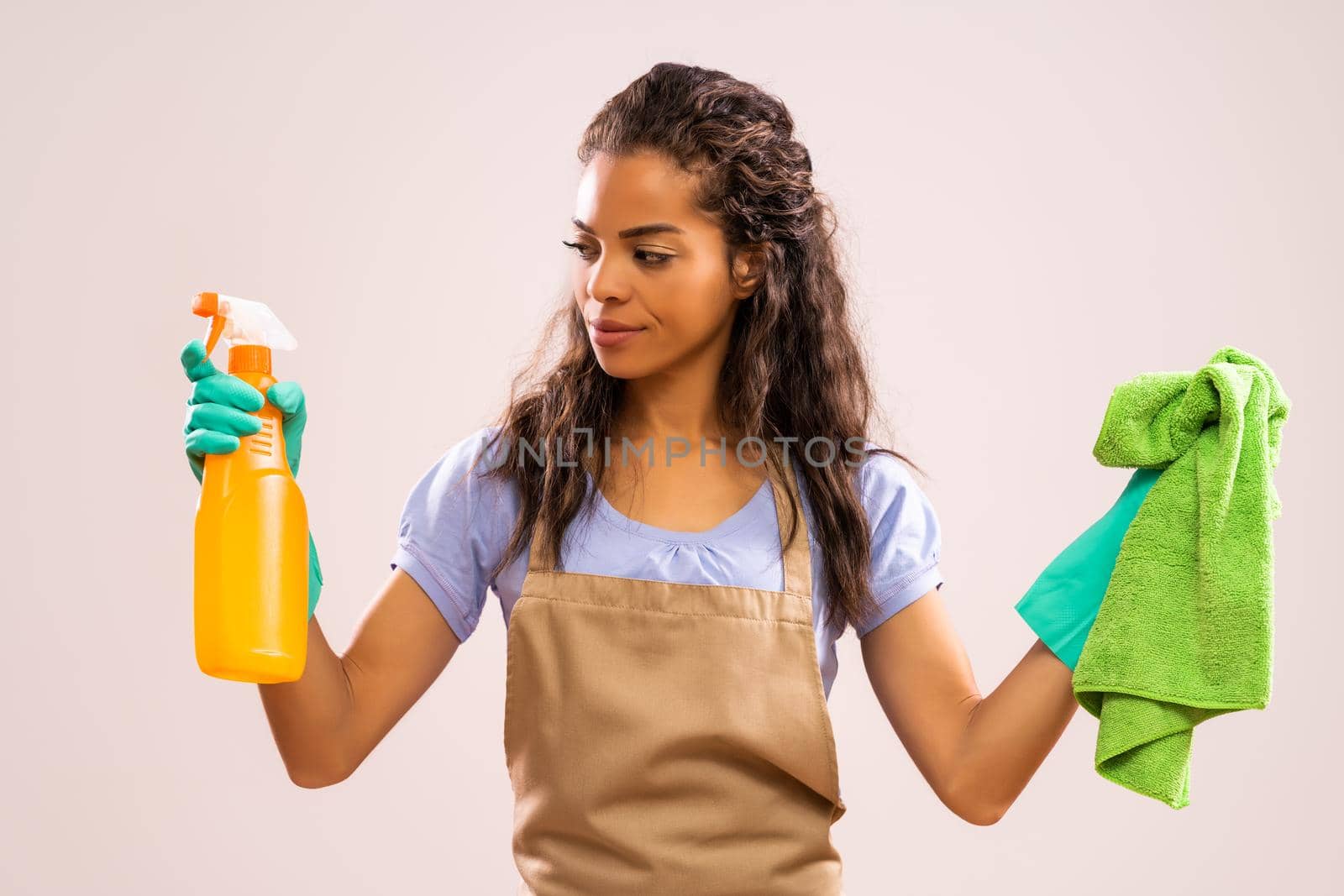 Portrait of african-american professional maid who is tired of cleaning.
