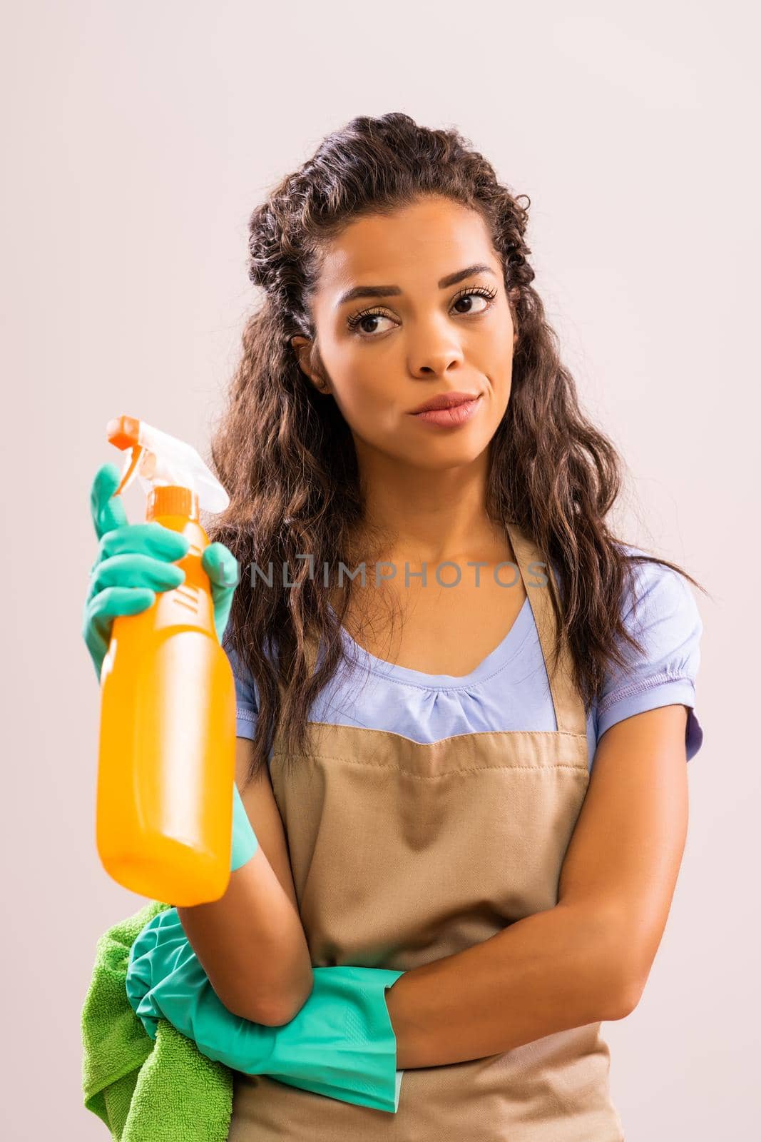 Portrait of african-american professional maid who is tired of cleaning.